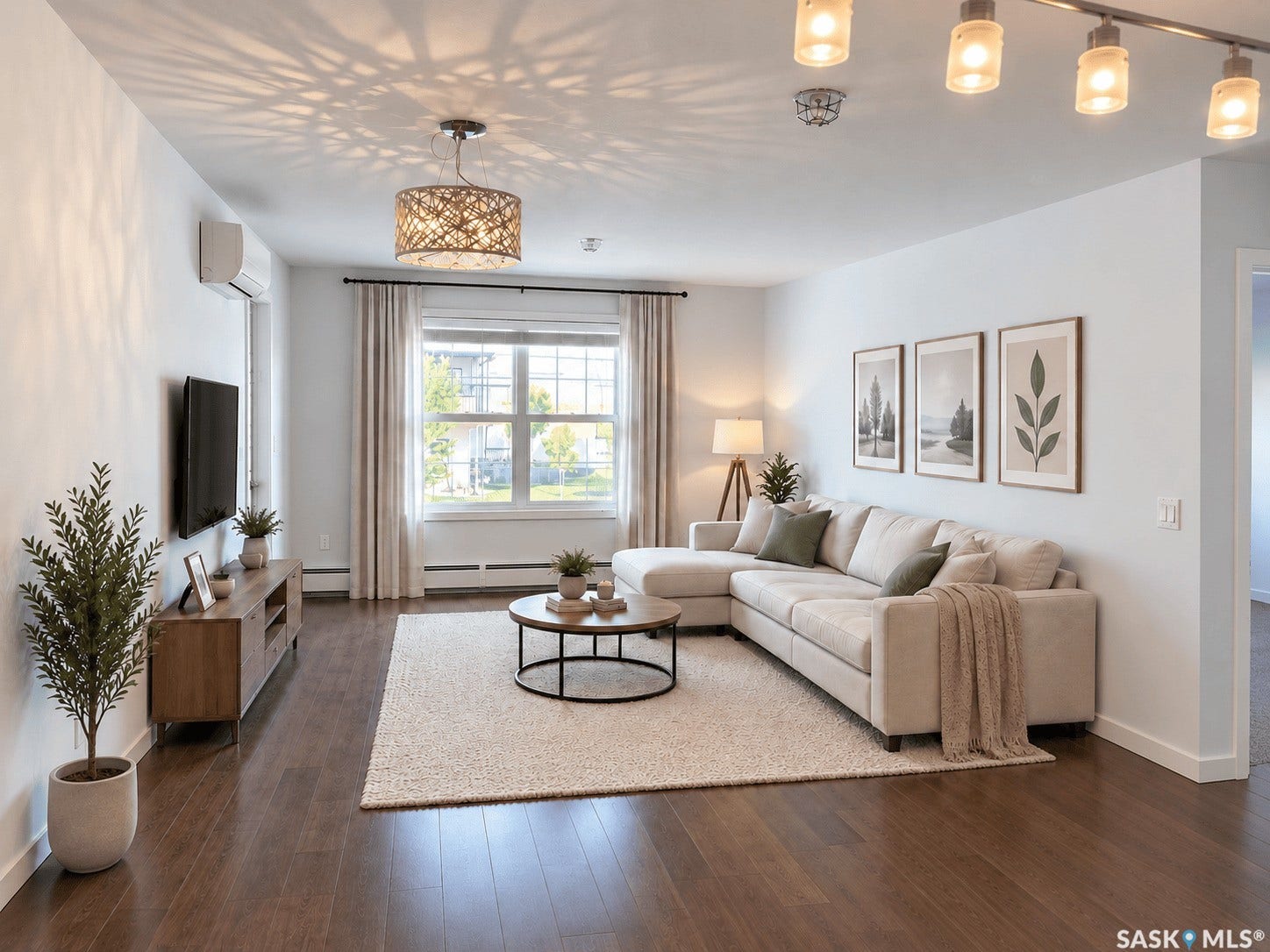 Hardwood-style flooring, large window with natural light, recessed lighting, track lighting, and a chandelier