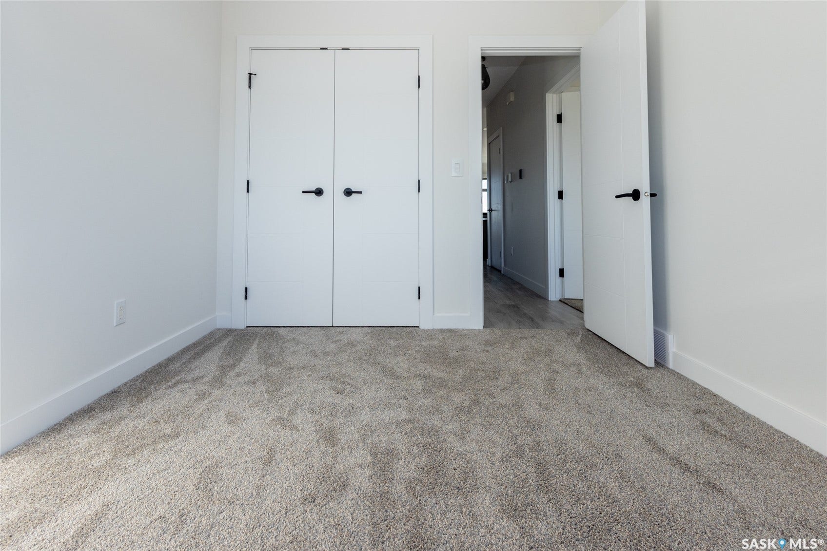 Warm-toned carpeting and bright white walls
