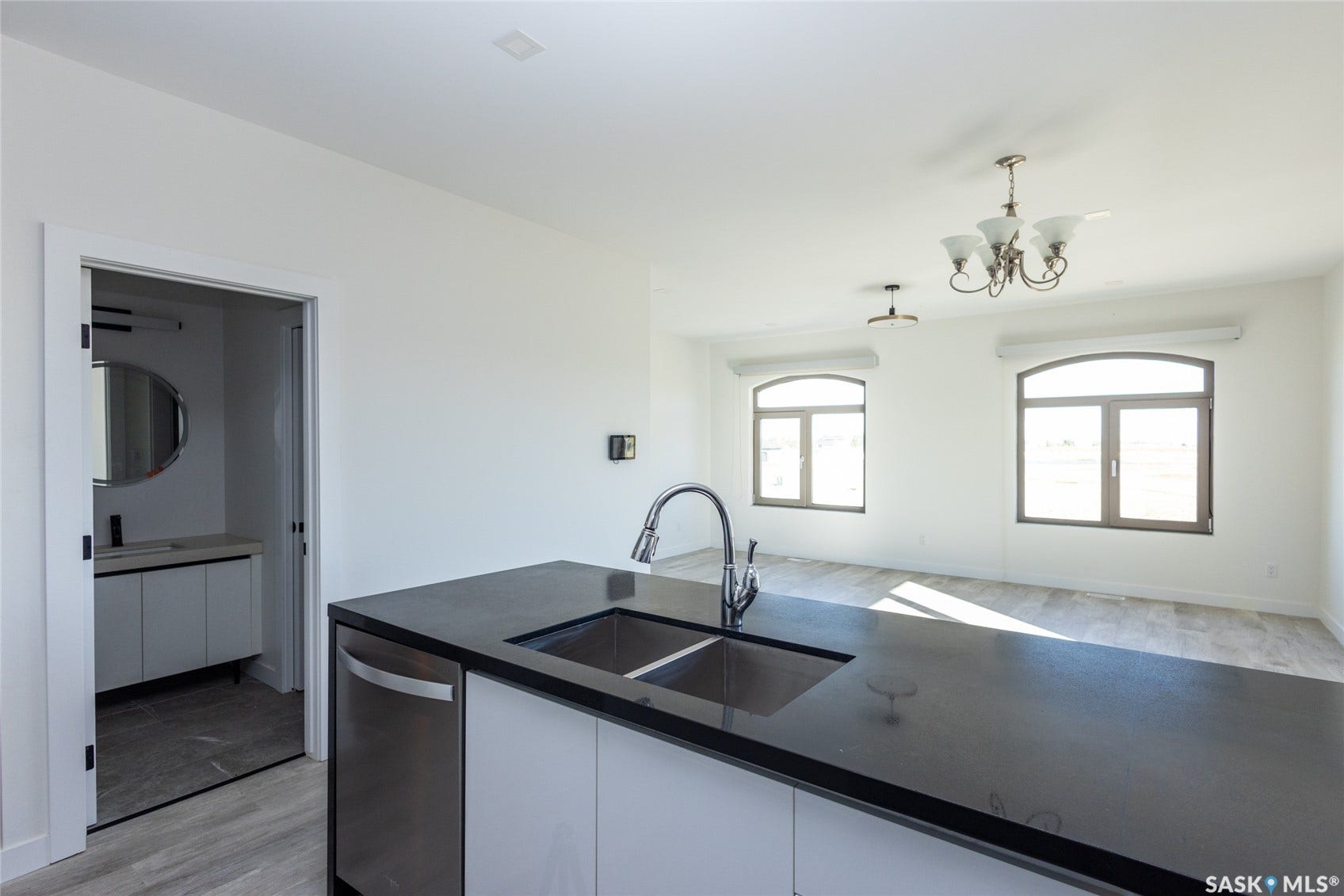 Kitchen island with a dark countertop and stainless steel sink
