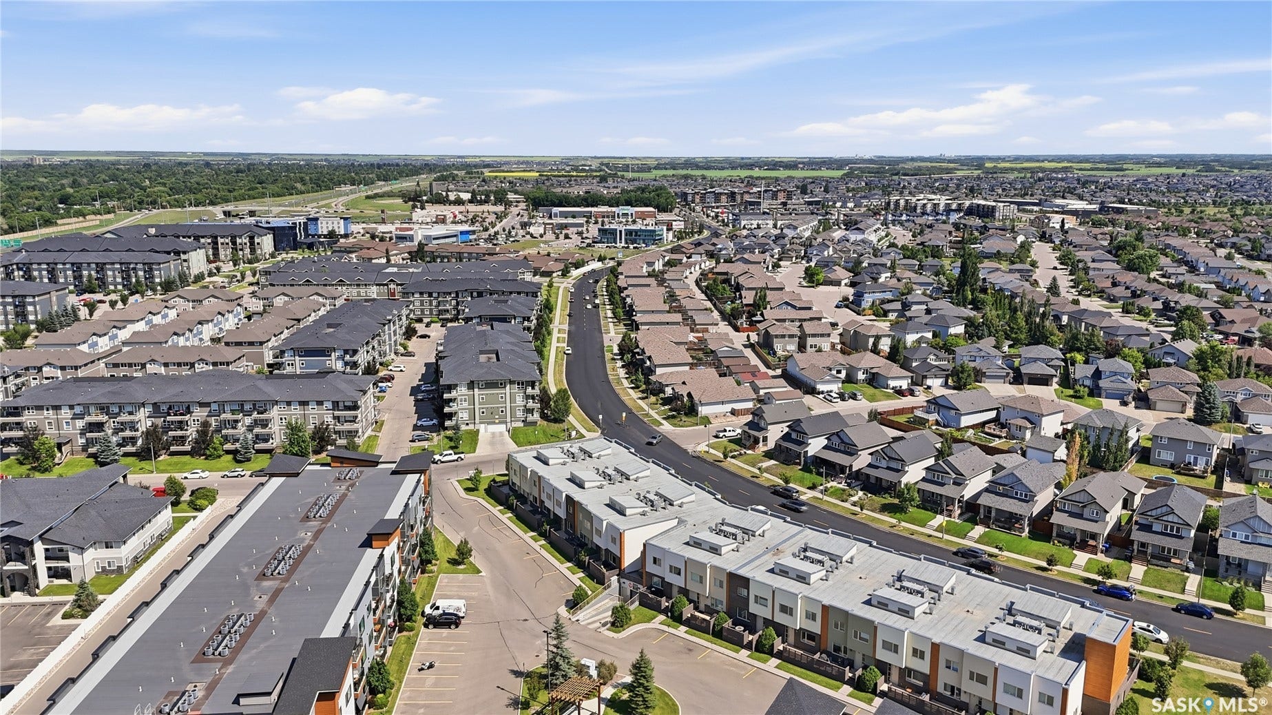 Aerial perspective of a developed residential area featuring a mix of single-family homes and multi-story apartment buildings