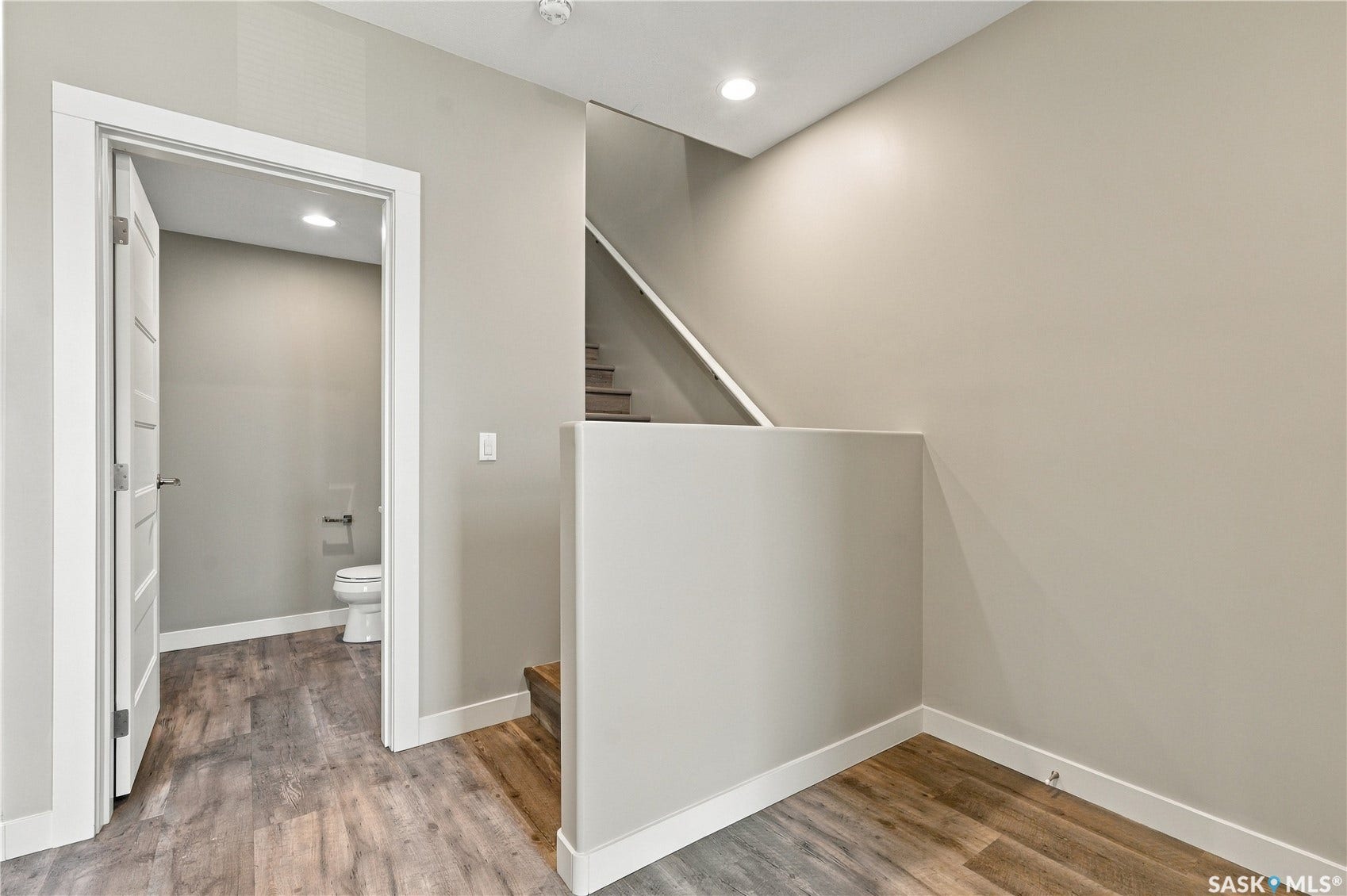 Wood-finish flooring throughout, with neutral wall paint and white trim