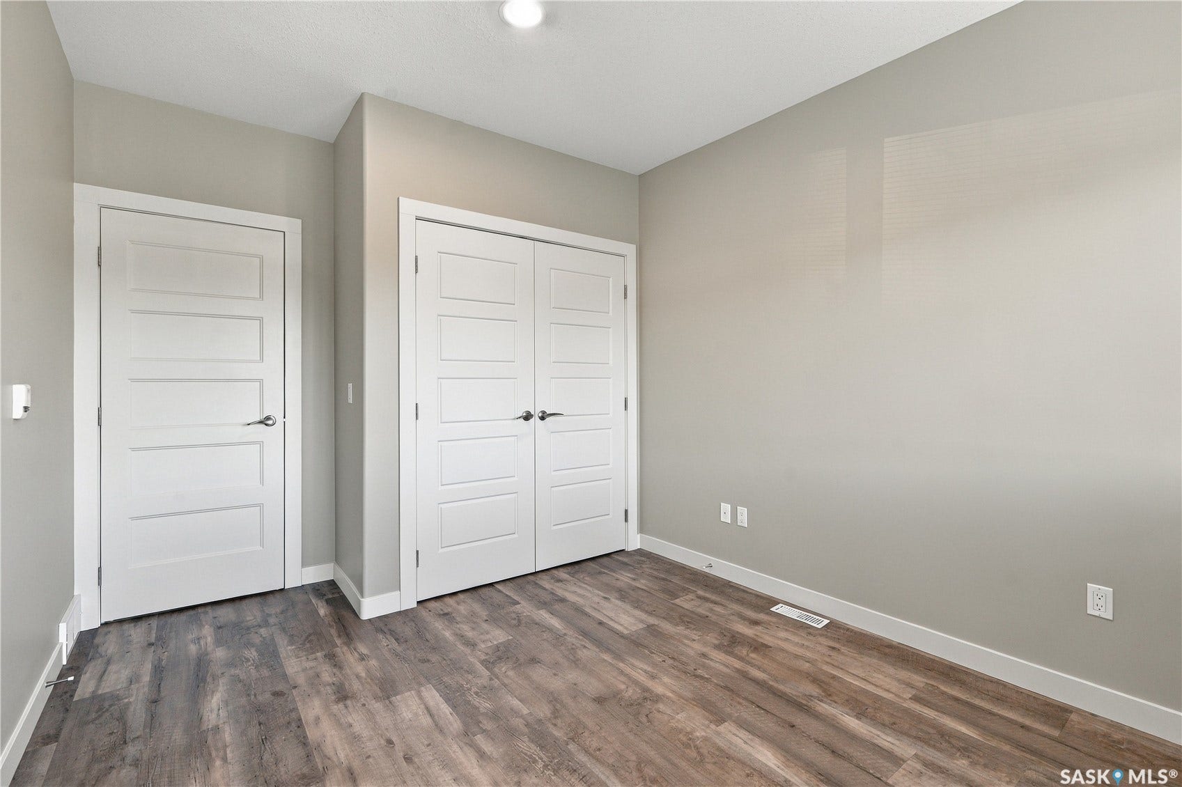 Wood-finish flooring, recessed ceiling lighting, and solid core doors