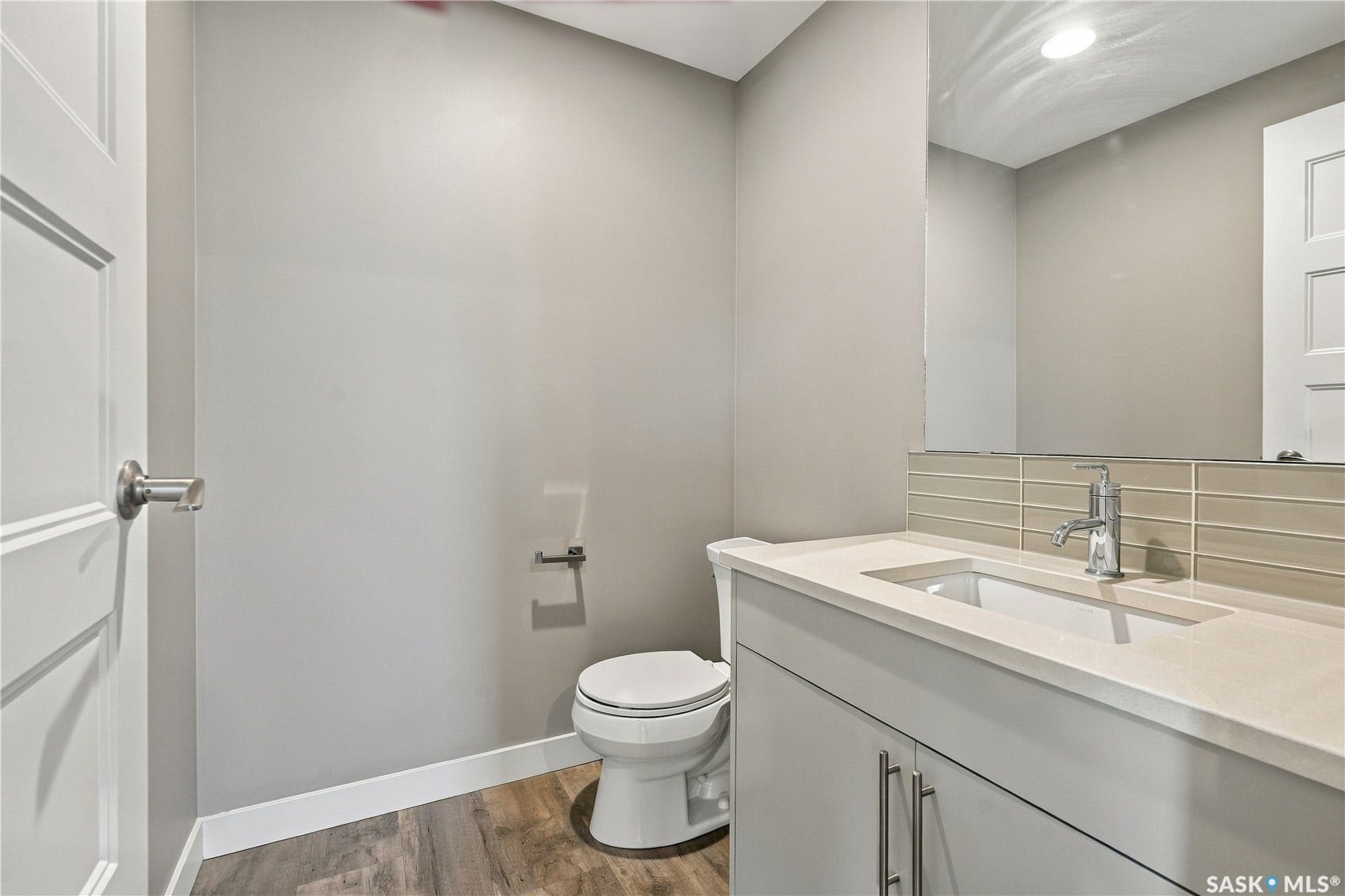 Vanity with an integrated rectangular sink, chrome faucet, and light-colored countertop