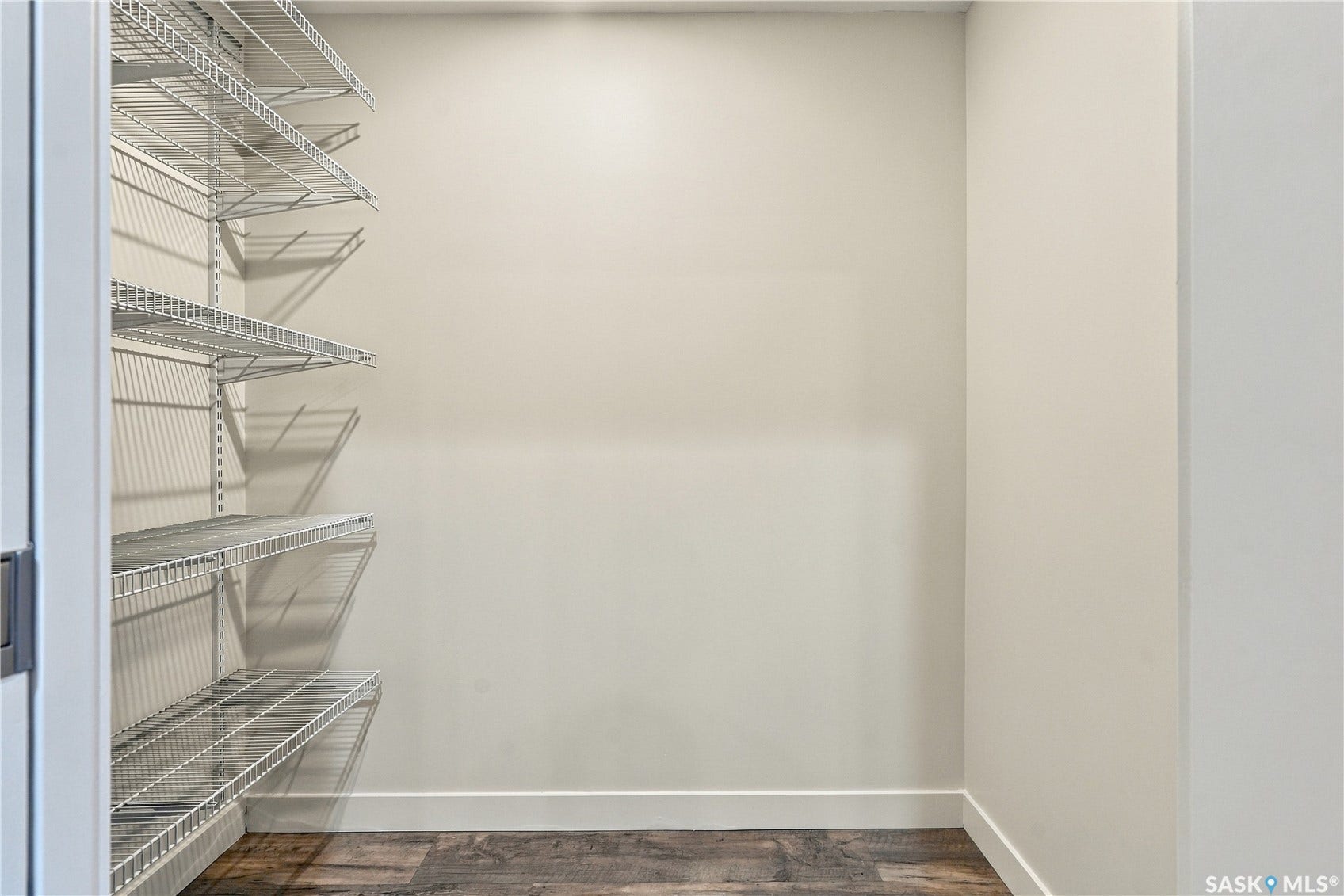 Built-in wire shelving system, durable wood-finish flooring, and crisp white baseboards