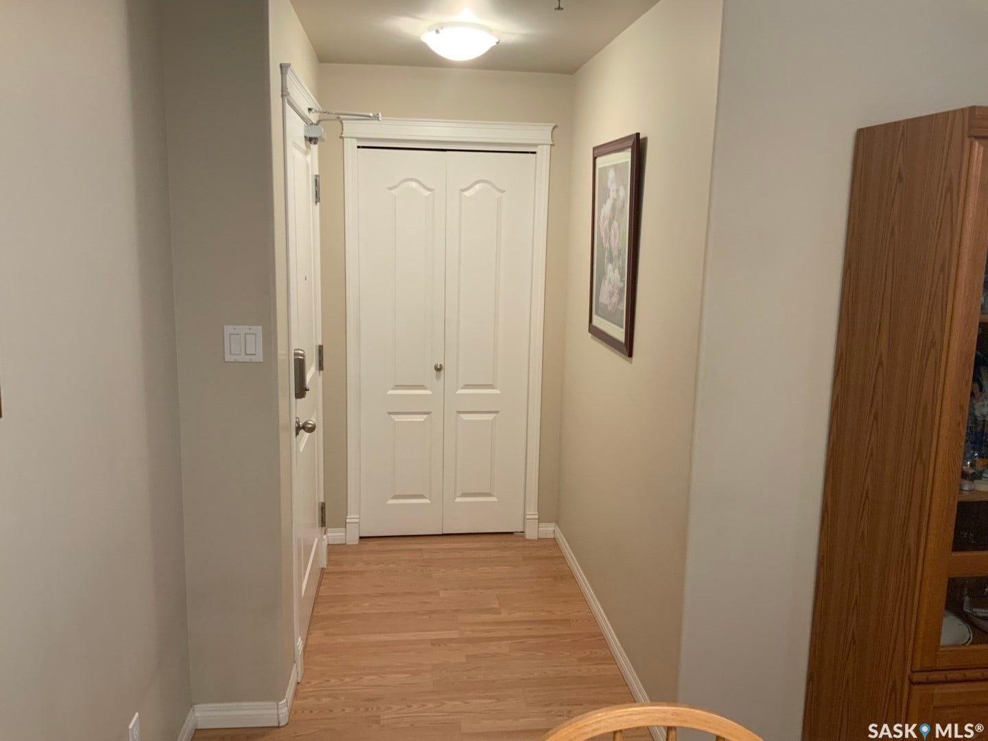 Wood-finish flooring with neutral wall tones and white trim