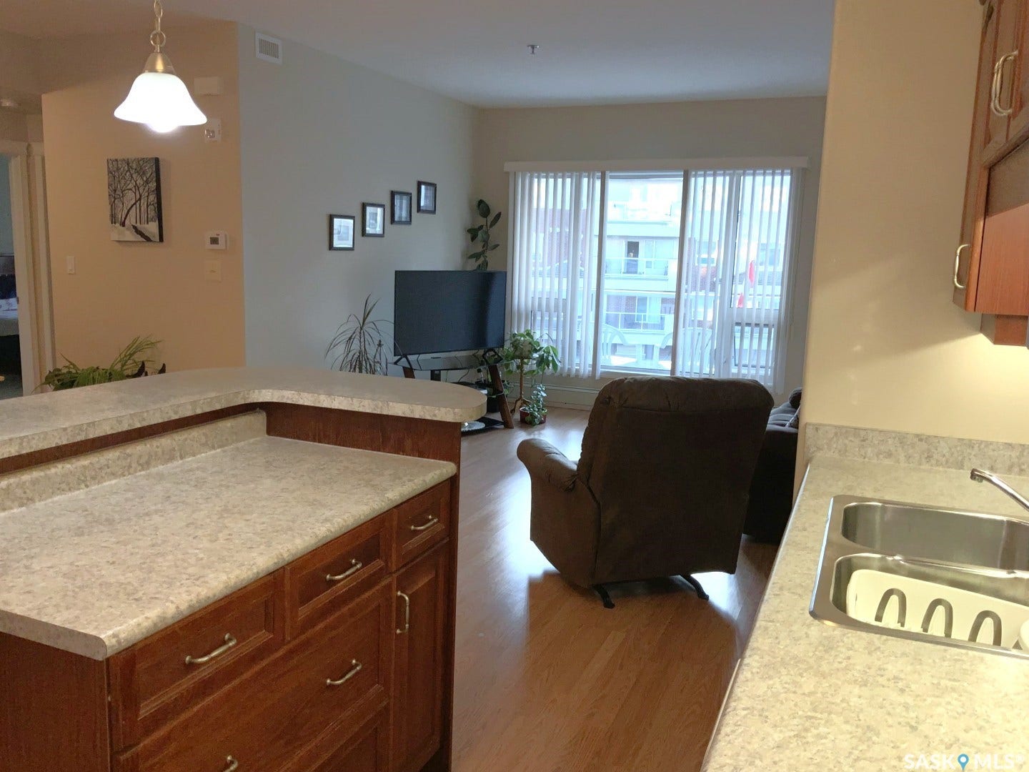 Kitchen island with integrated storage cabinetry and light-toned countertops