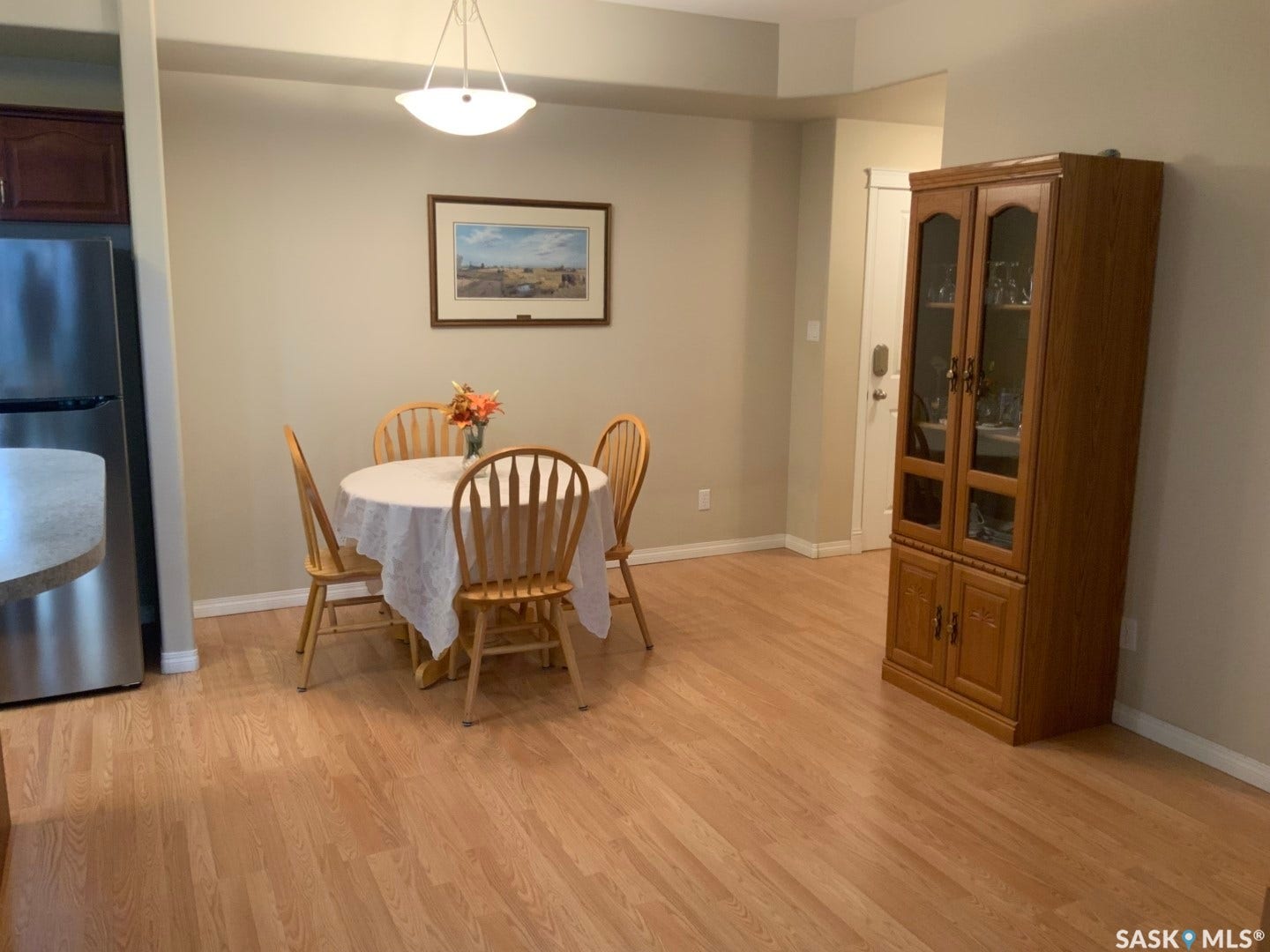 Wood-finish flooring throughout, with a semi-flush mount ceiling light fixture