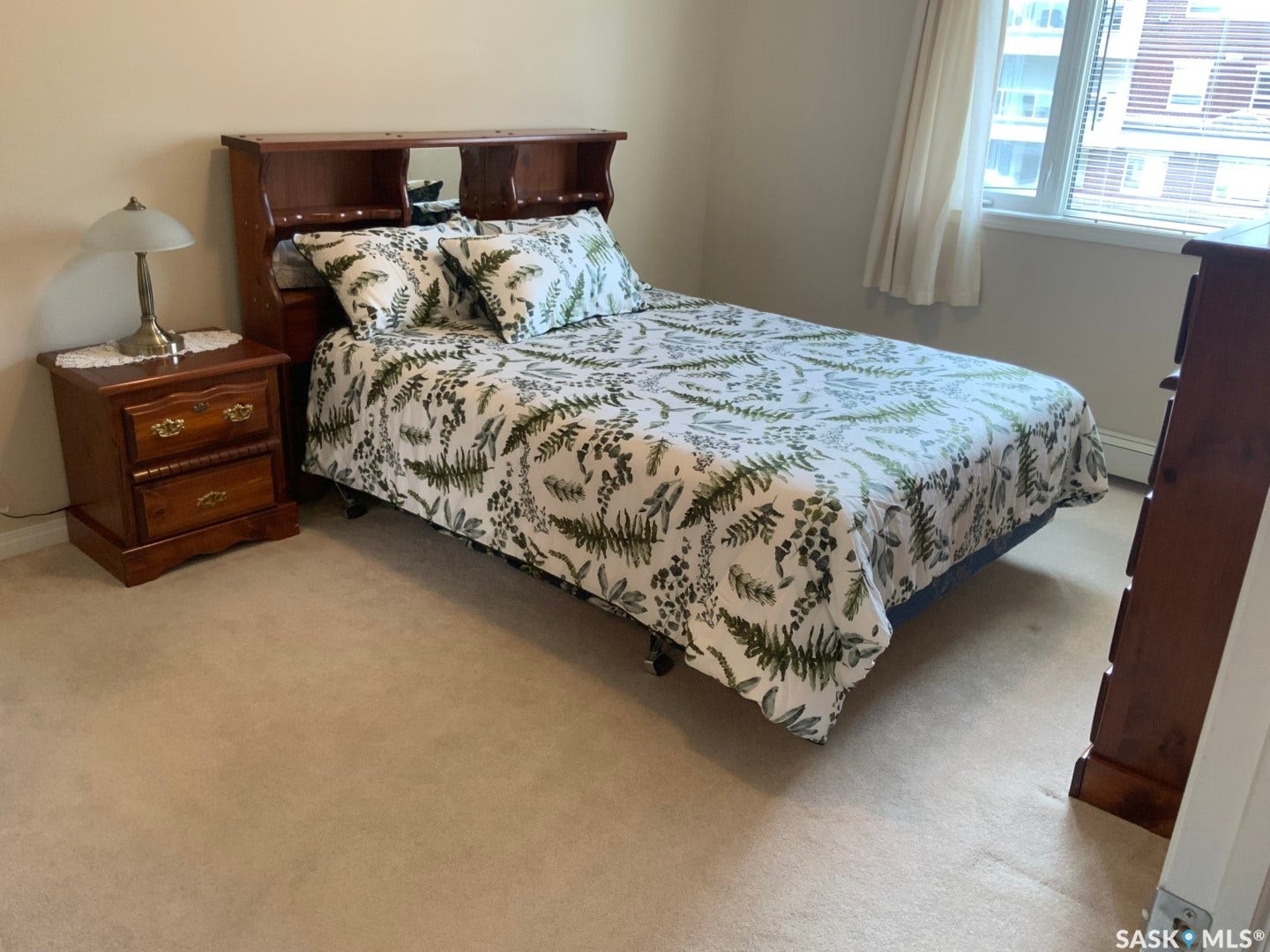 Carpeted flooring, light-toned walls, and a window with blinds