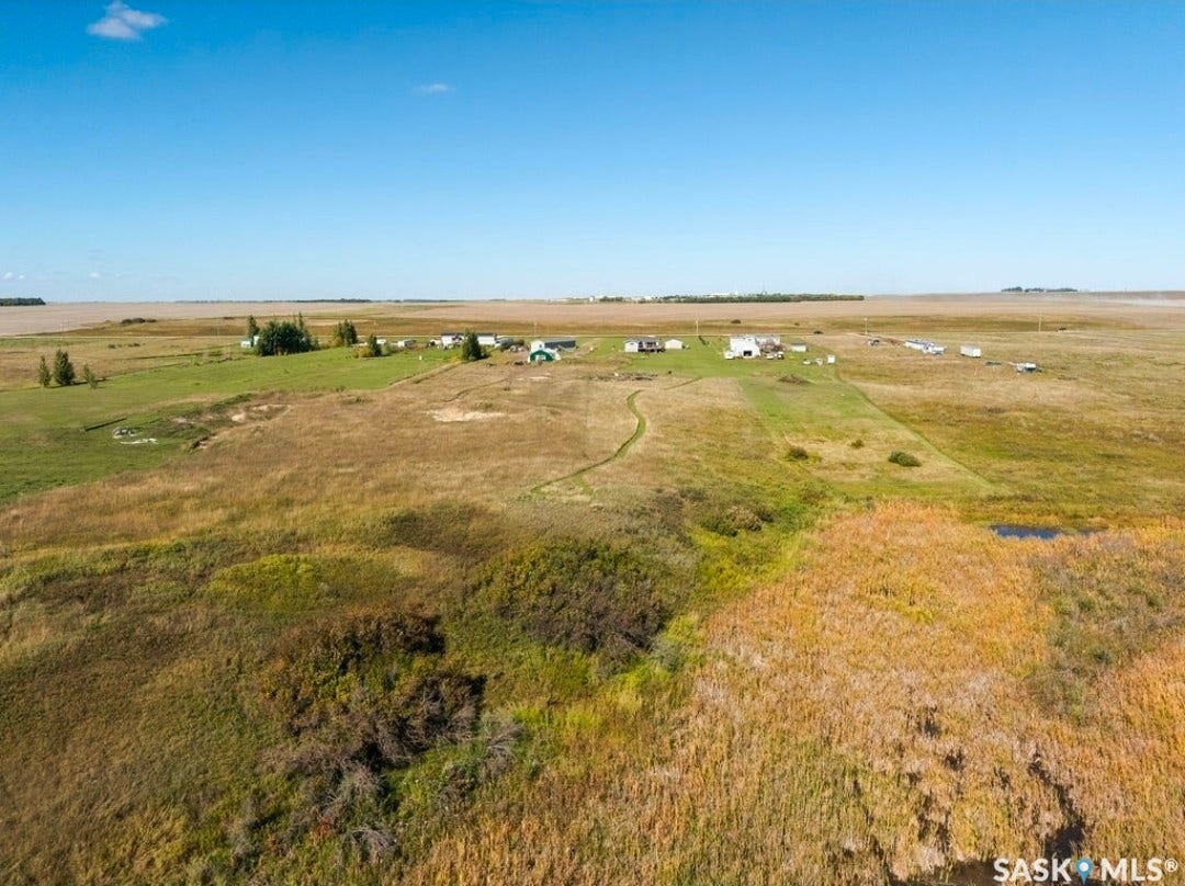 Expansive land parcel featuring multiple structures and natural terrain