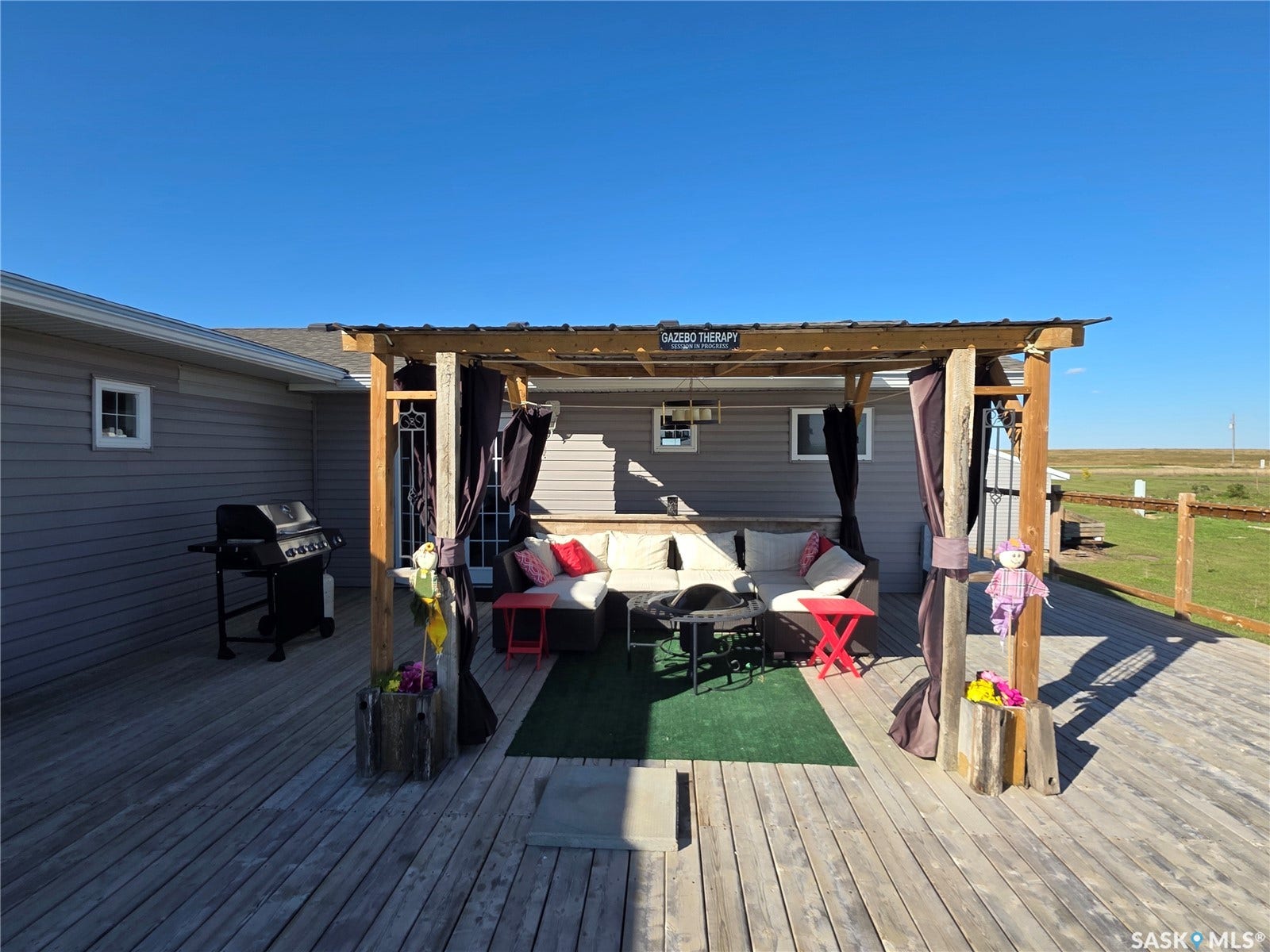 Expansive exterior wood deck featuring a covered pergola structure