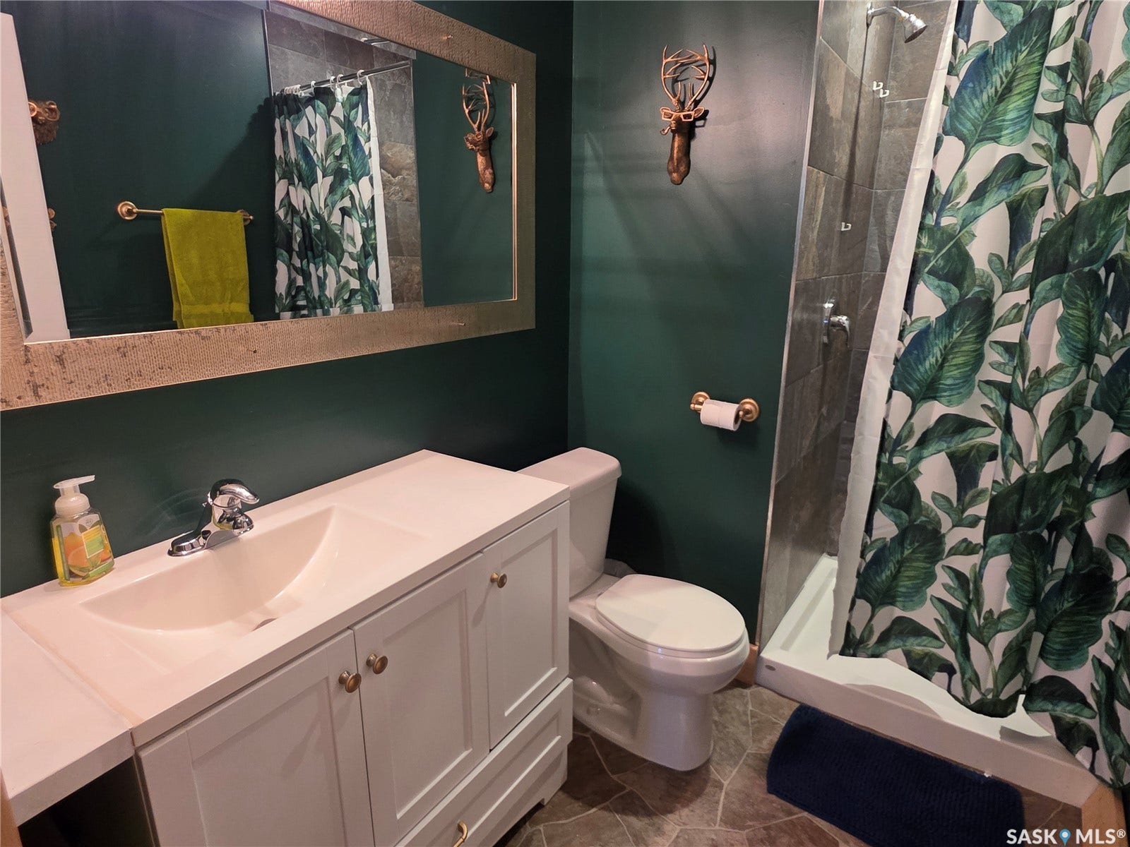 White vanity with integrated sink, and gold-tone hardware