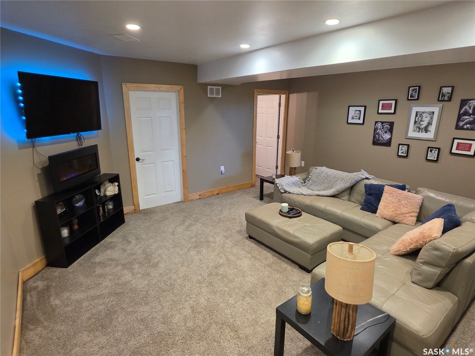 Recessed ceiling lighting, paneled doors with dark hardware, natural wood trim, and wall-to-wall carpeting
