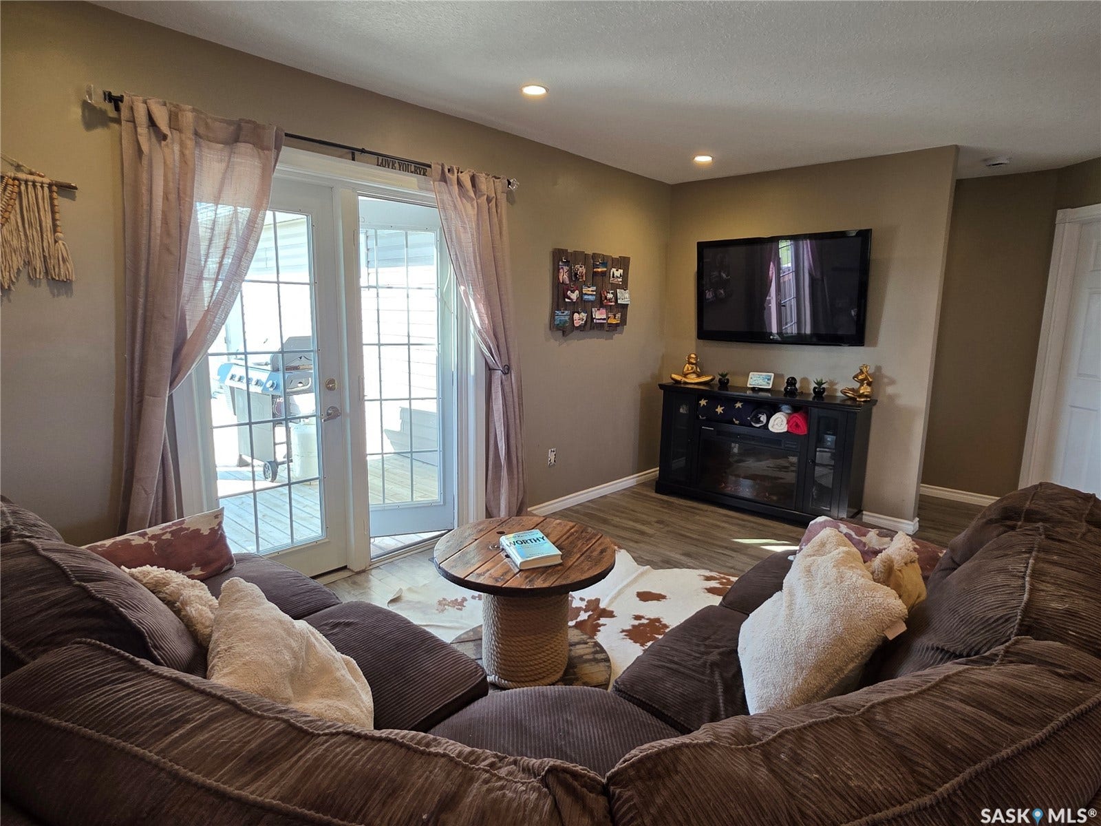 Glass-paned patio doors, recessed ceiling lighting, laminate flooring, and an electric fireplace