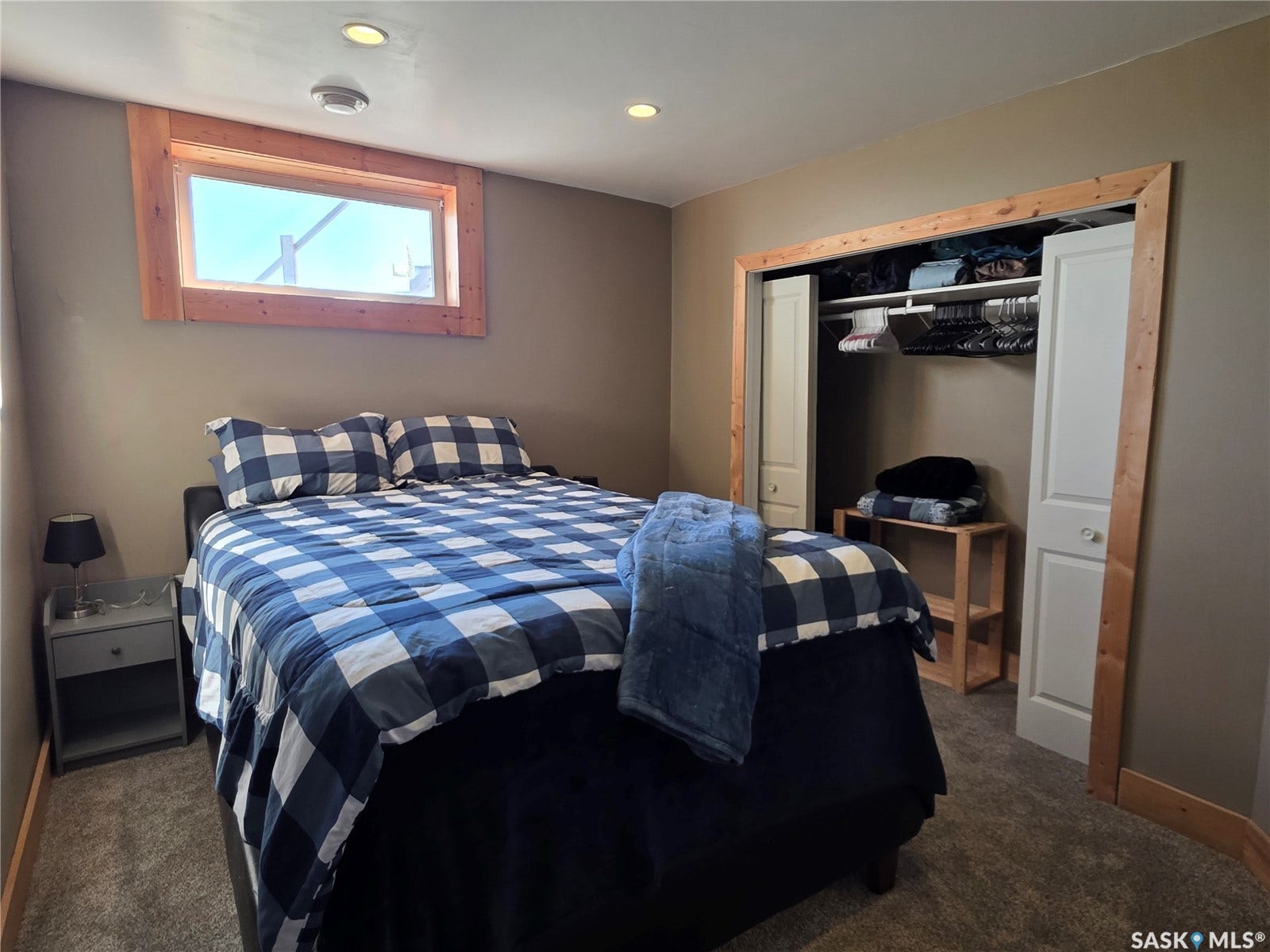 Recessed ceiling lighting, wood-trimmed window, closet, and carpeted flooring