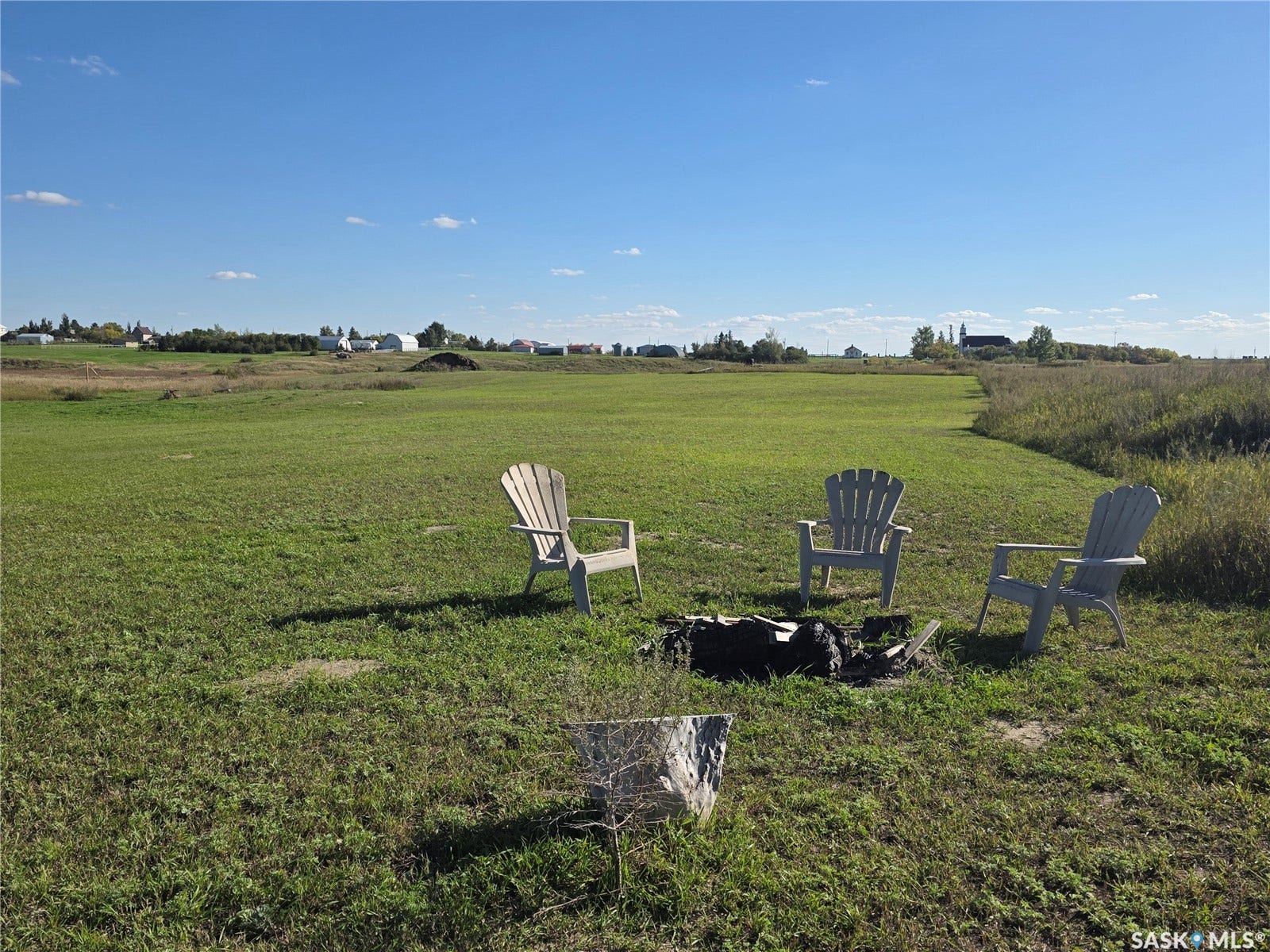 Expansive green space with a clear sky backdrop