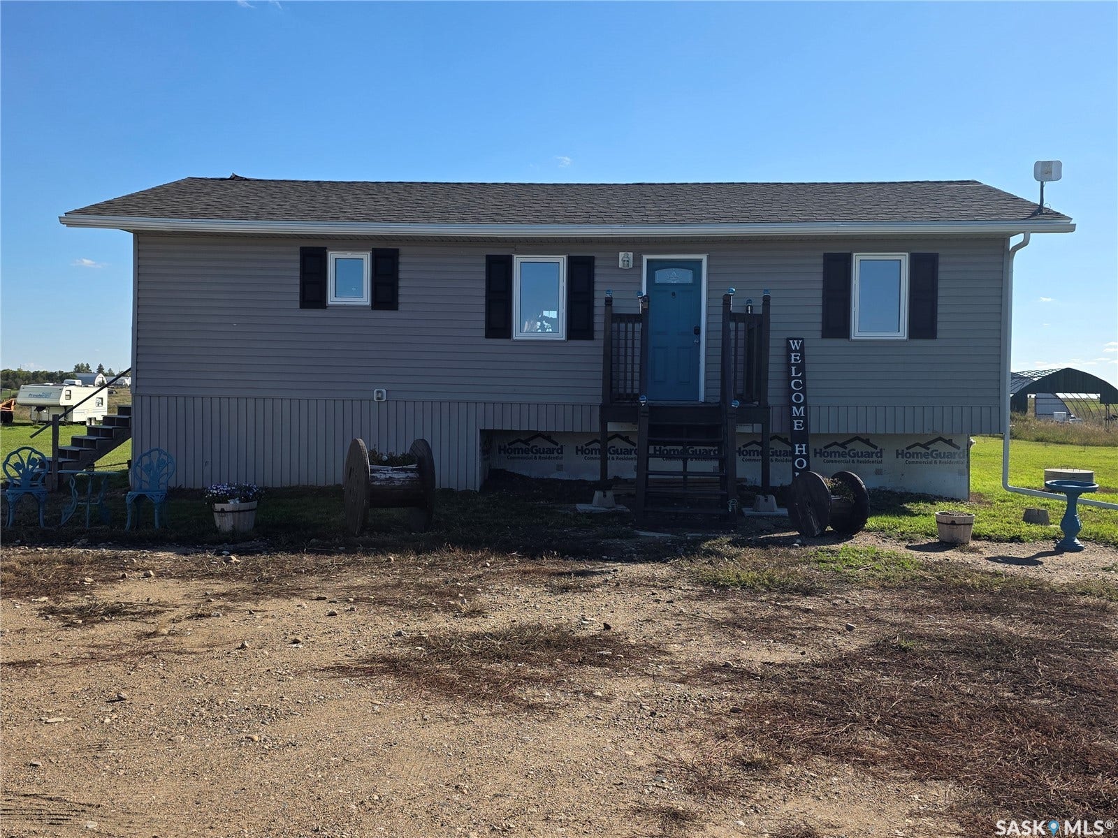 Gray horizontal siding exterior with dark shutters