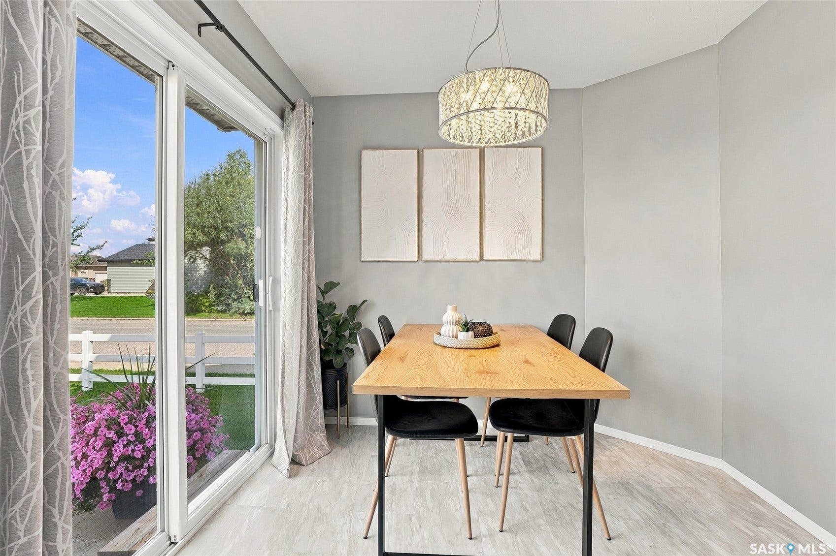 Sliding glass door, wood-finish flooring, recessed lighting, and a modern chandelier