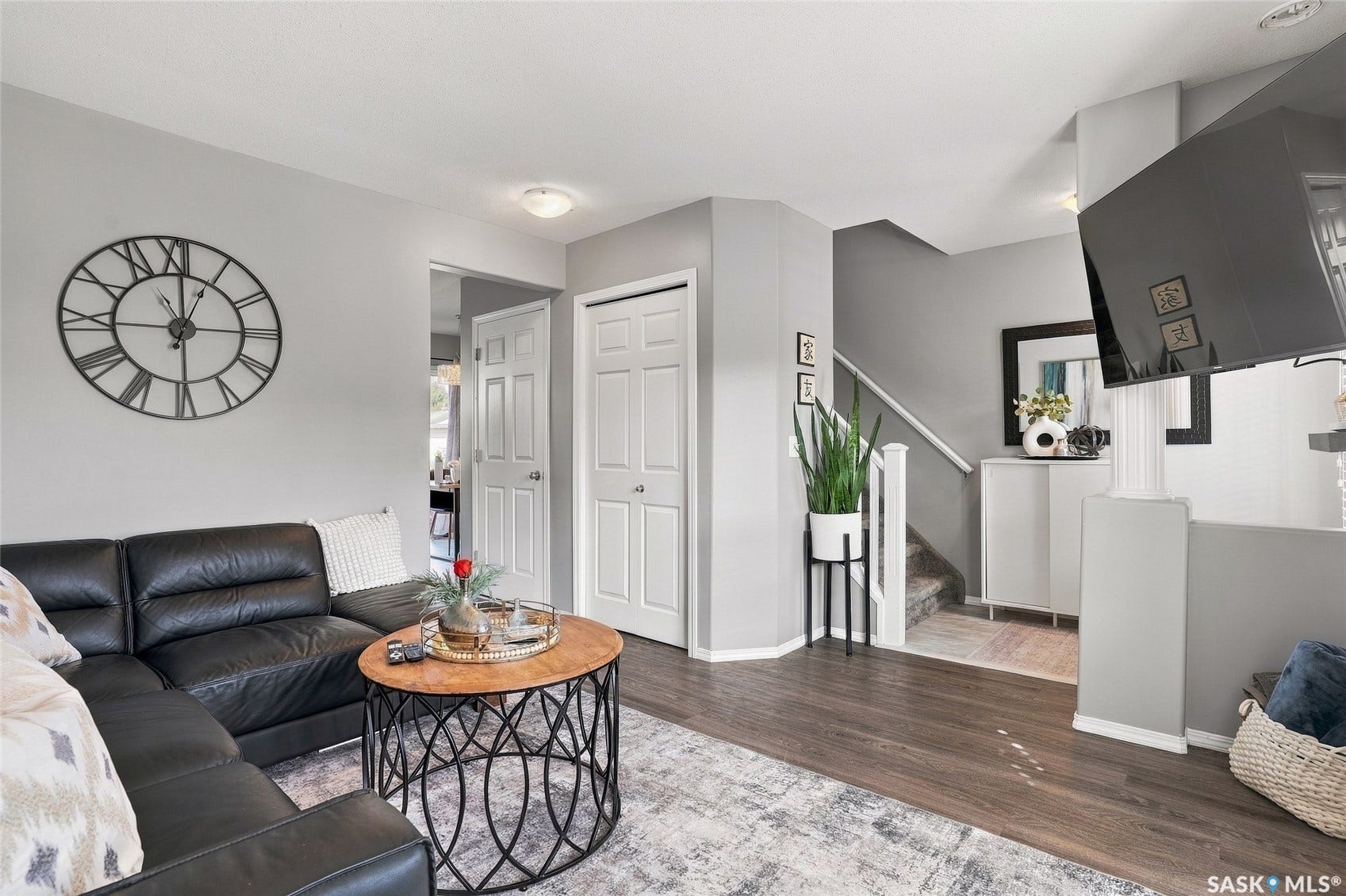 Wood-finish flooring throughout, complemented by light gray wall paint