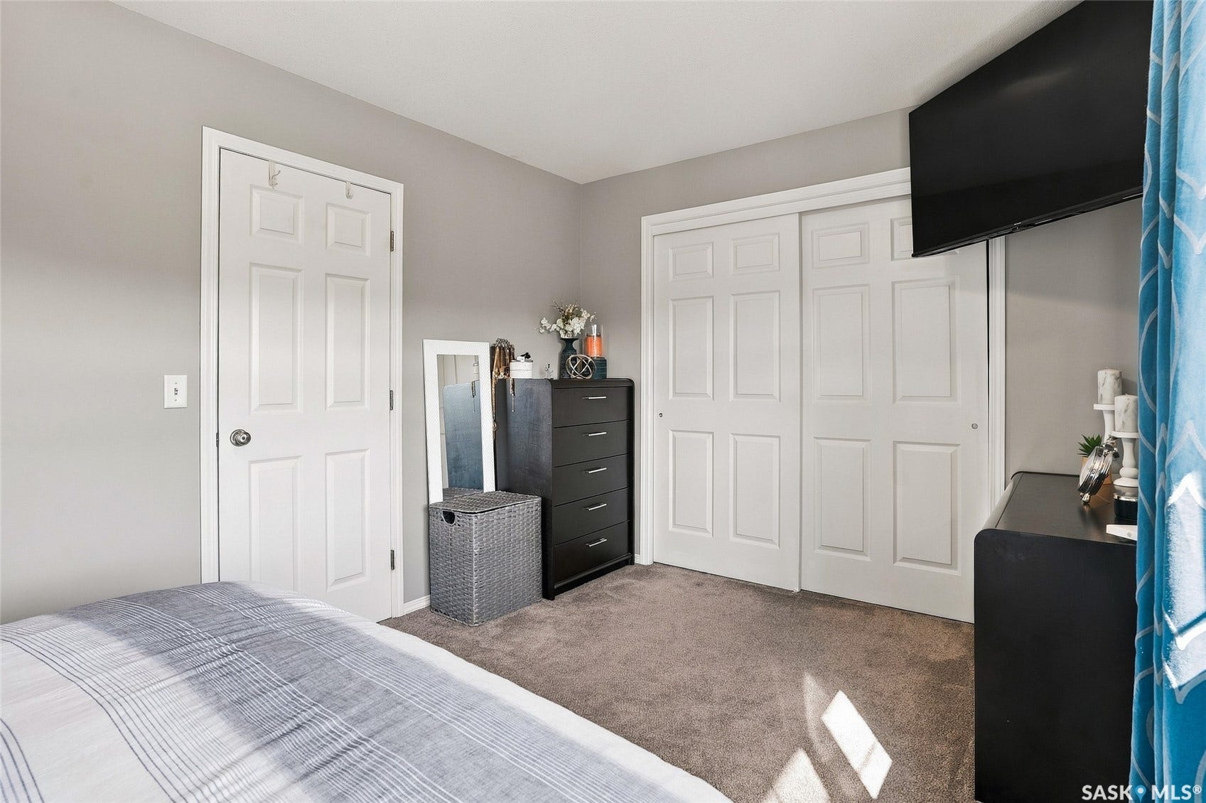 Neutral wall paint, white panel door, and sliding closet doors