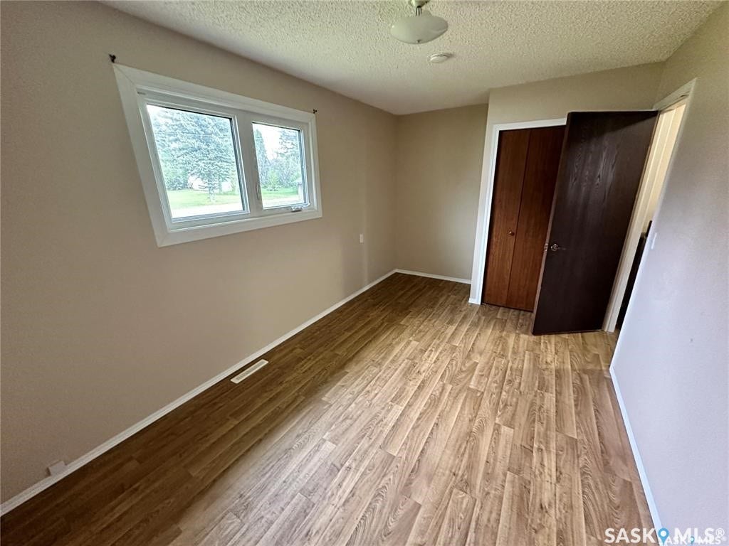 Wood-finish flooring throughout, complemented by a double-panel window with white trim