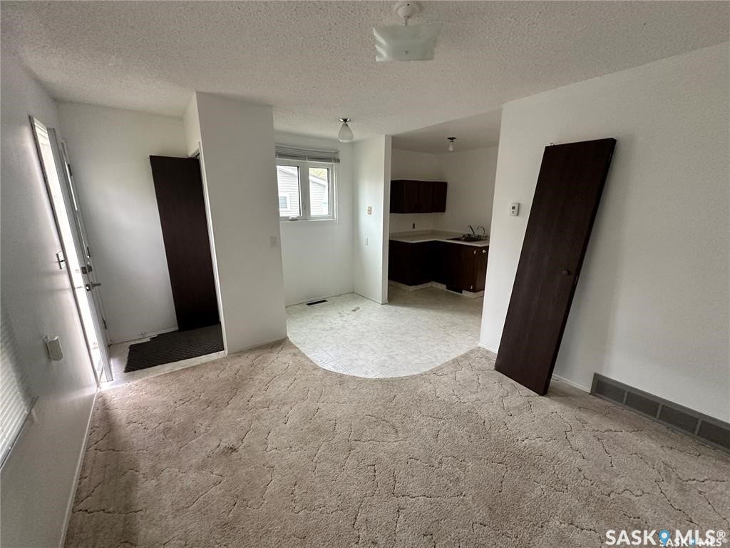 Recessed kitchen area with dark wood-finish cabinetry
