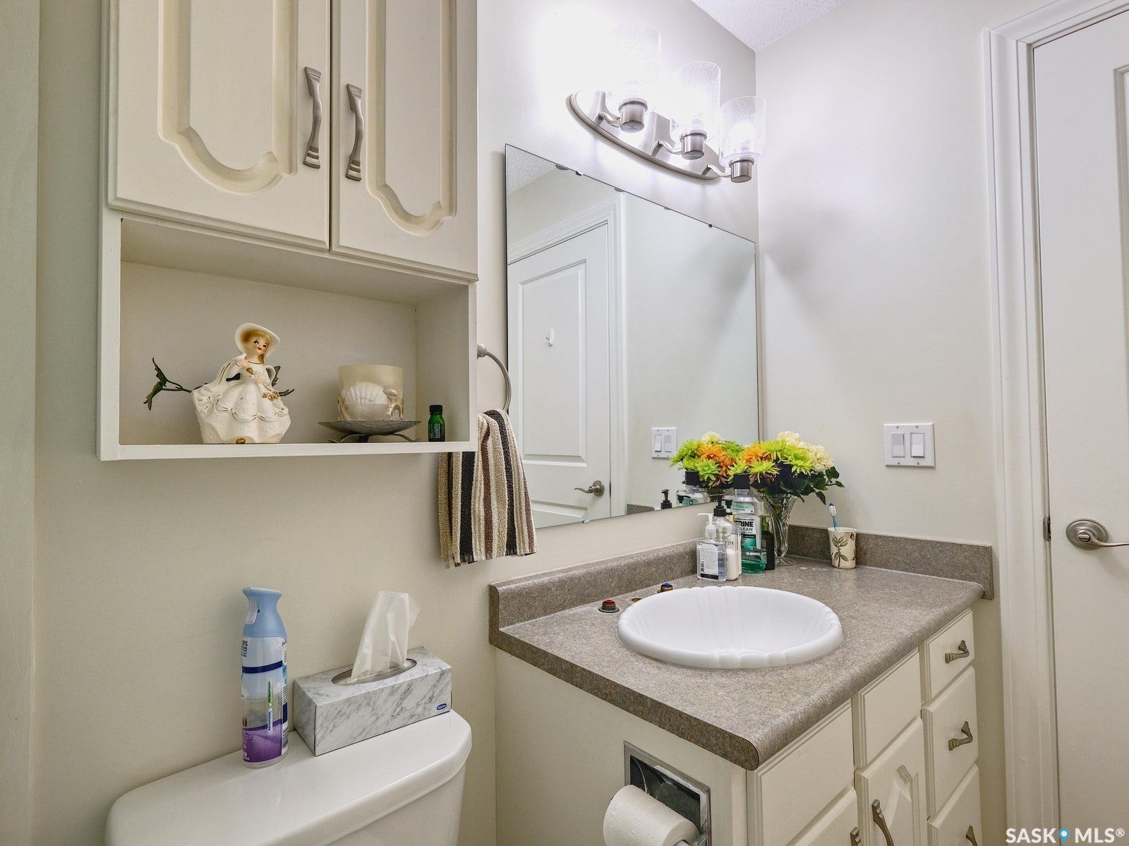 305 1st Street W, #302, Rosetown SK S0L 2V0 Built-in vanity with an integrated sink, ample counter space, and decorative cabinetry
