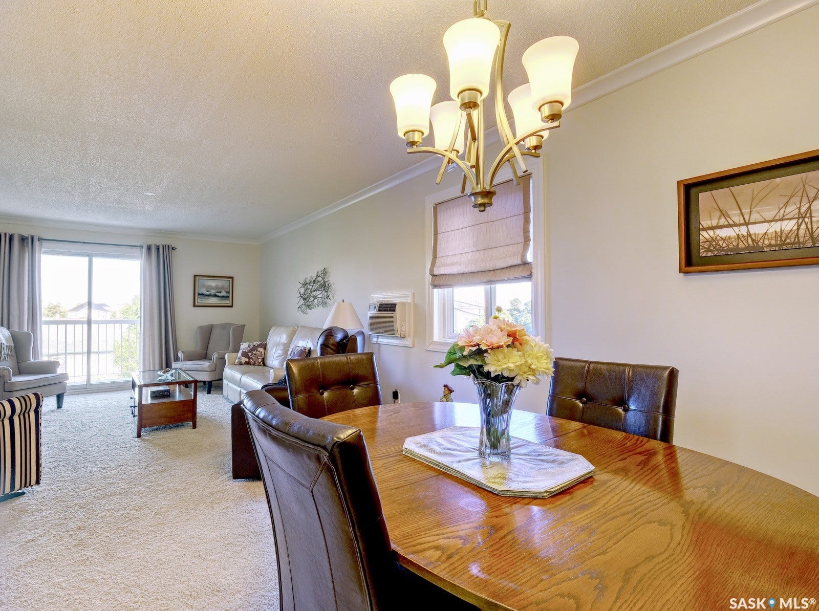 305 1st Street W, #302, Rosetown SK S0L 2V0 Dining area featuring a wood-finish oval table and a multi-arm chandelier
