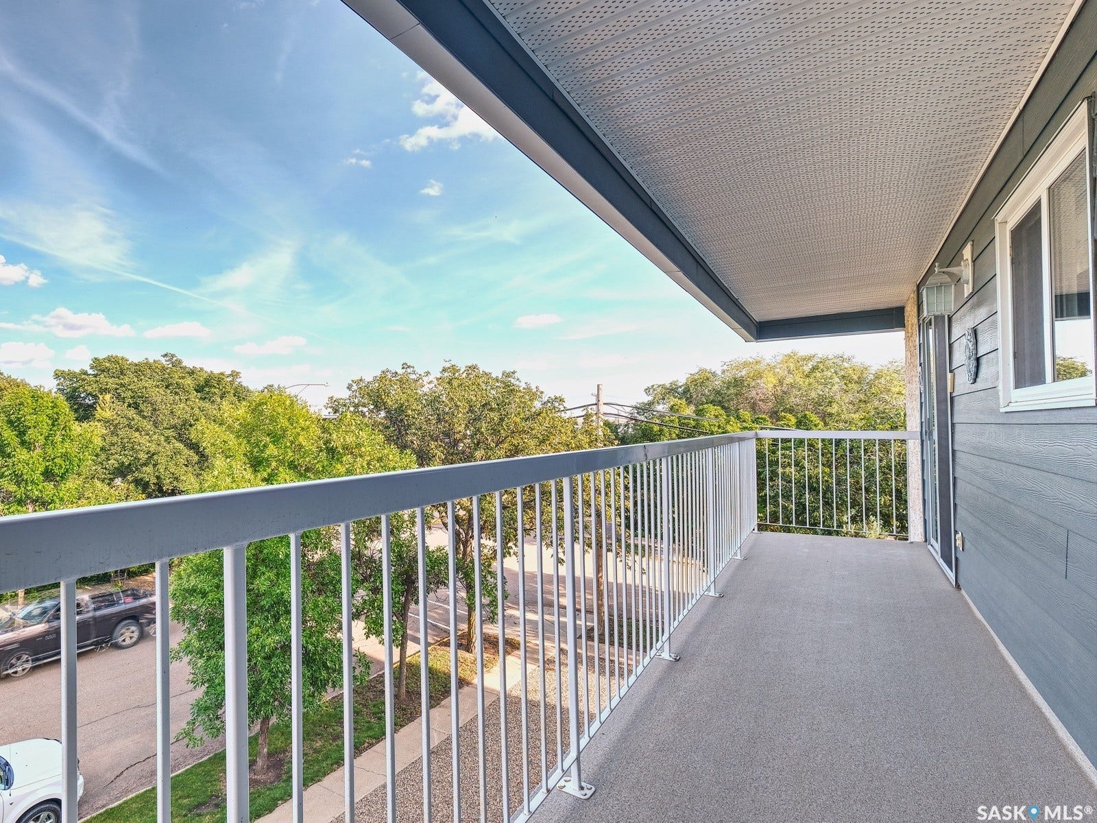 305 1st Street W, #302, Rosetown SK S0L 2V0 Expansive balcony featuring a textured floor, white metal railing, and a textured ceiling