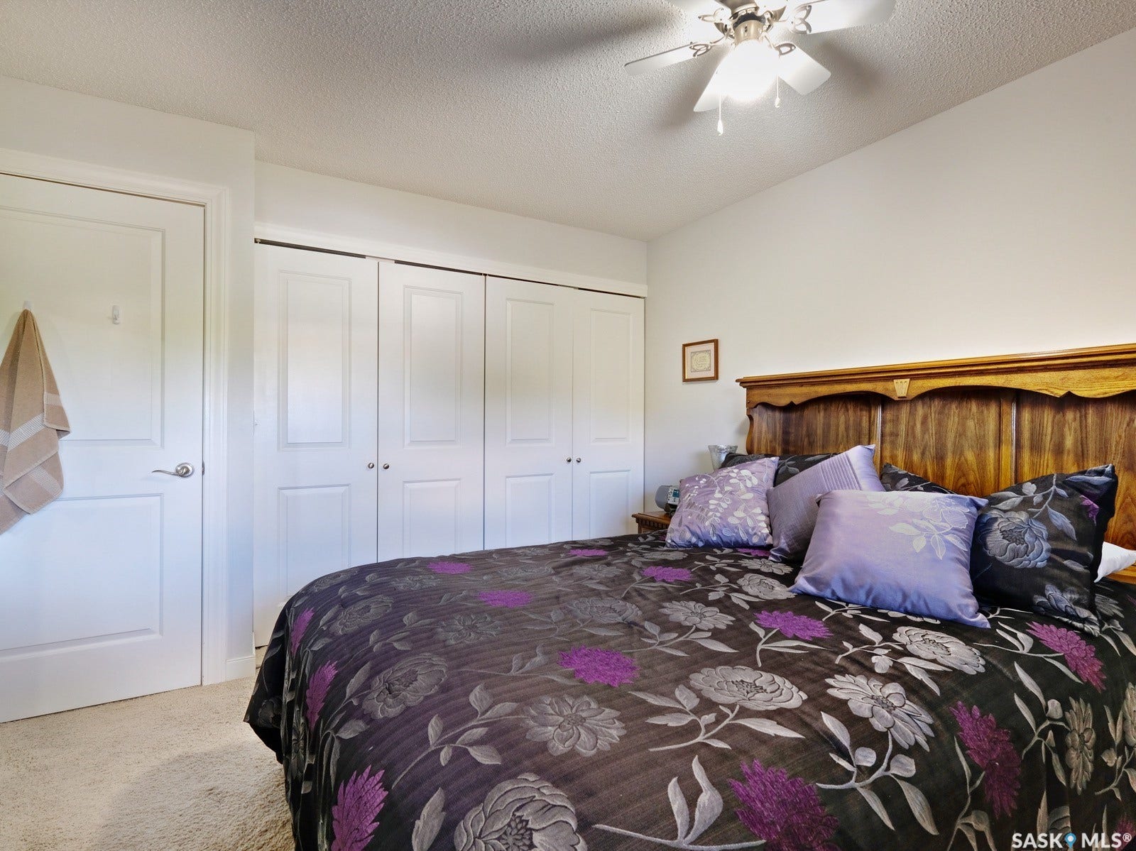 305 1st Street W, #302, Rosetown SK S0L 2V0 White walls with textured ceilings, light-toned carpeting, and a ceiling fan with integrated lighting