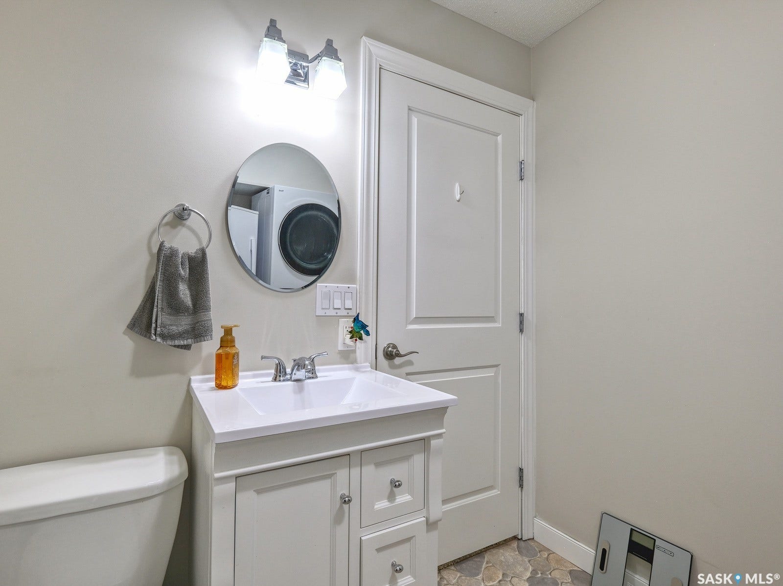 305 1st Street W, #302, Rosetown SK S0L 2V0 Vanity with integrated sink, chrome faucet, and storage cabinetry