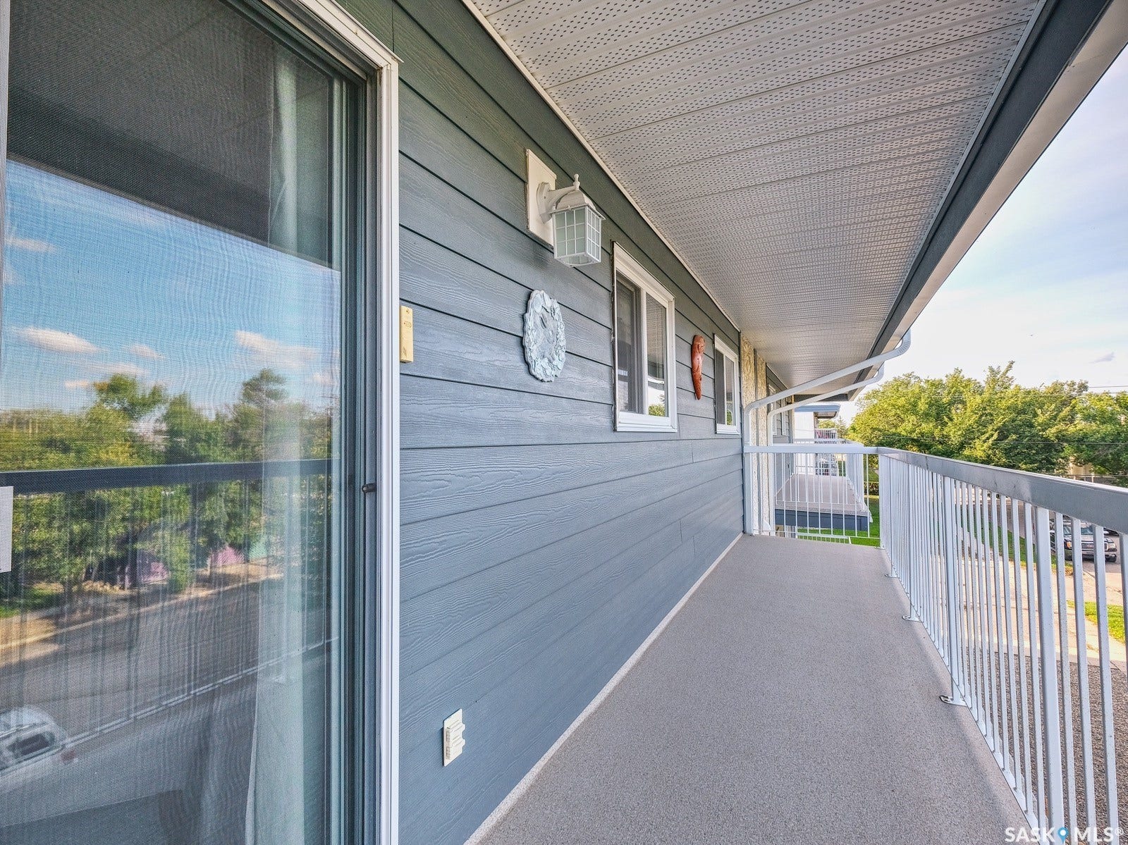 305 1st Street W, #302, Rosetown SK S0L 2V0 Covered balcony with textured flooring, white railings, and siding exterior