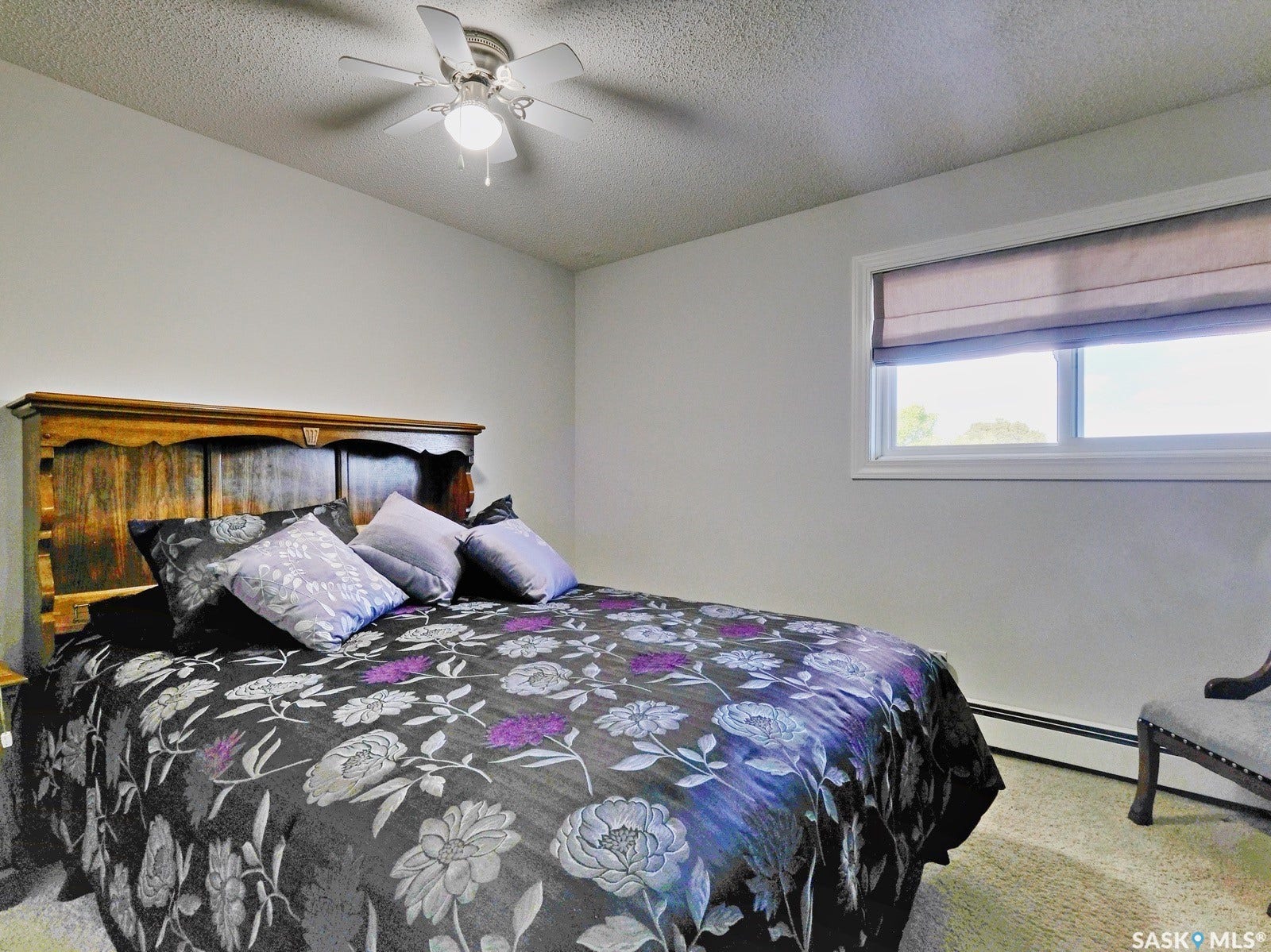 305 1st Street W, #302, Rosetown SK S0L 2V0 Window with a privacy blind, ceiling fan with integrated lighting, and carpeted flooring