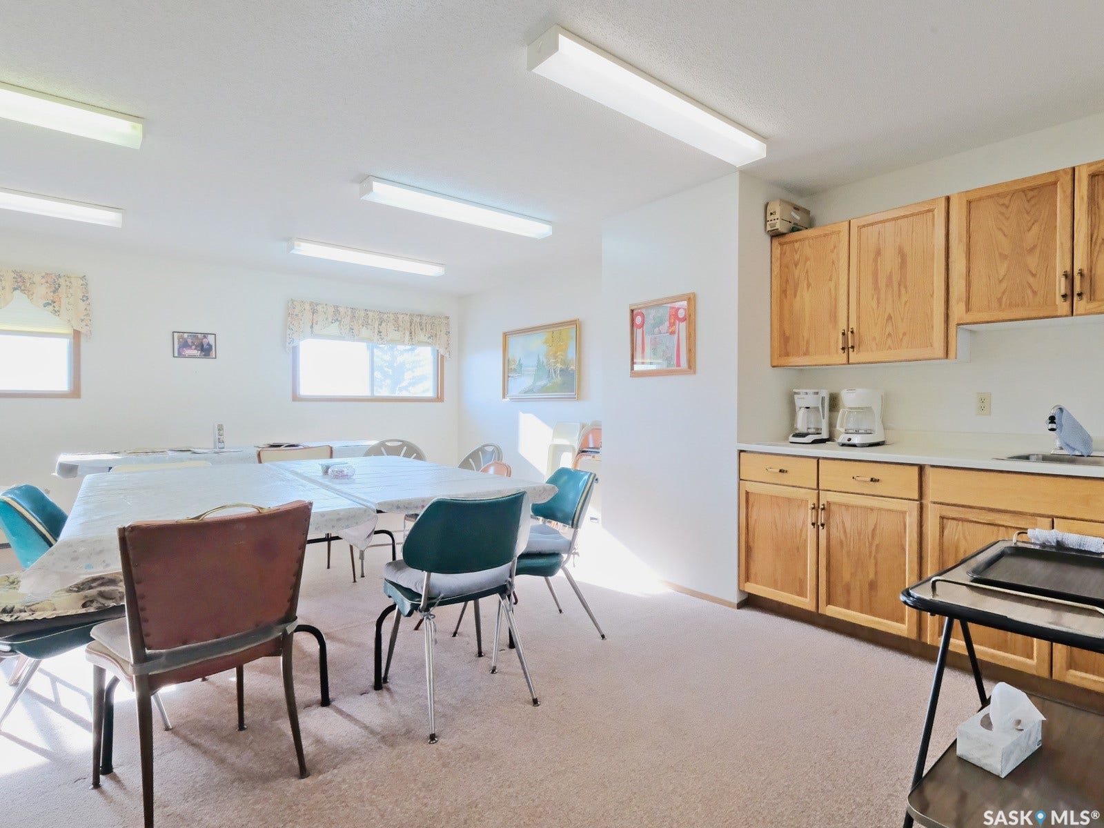 305 1st Street W, #302, Rosetown SK S0L 2V0 Functional kitchen area featuring wood-finish cabinetry and a built-in sink