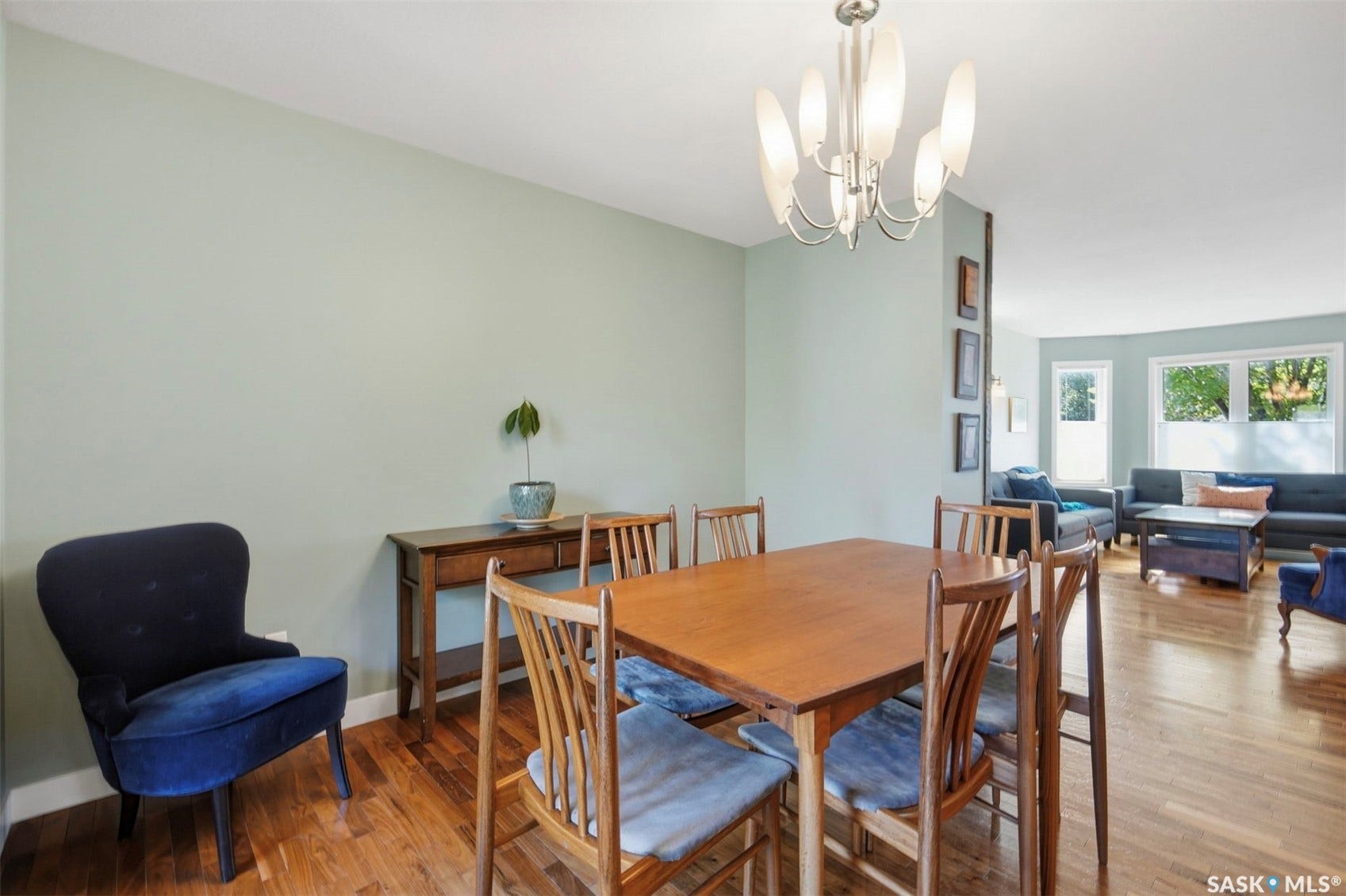 Wood-finish flooring throughout, featuring a contemporary chandelier and recessed lighting
