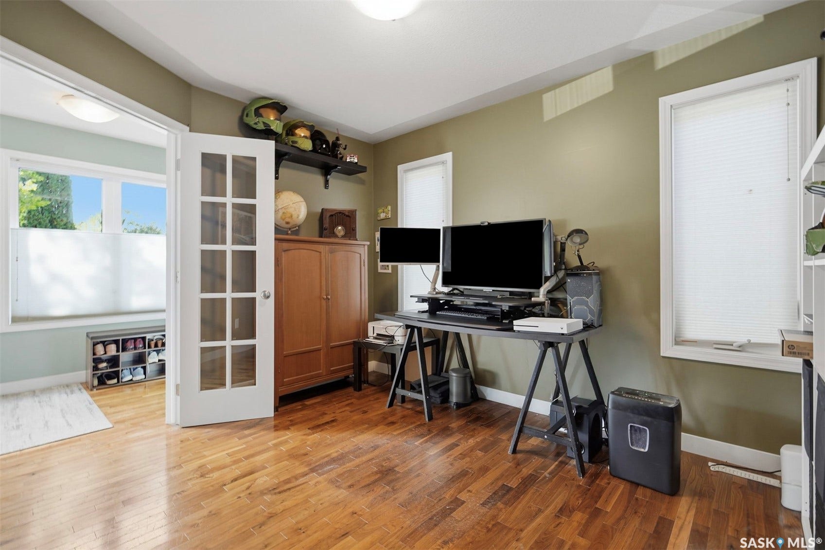 Hardwood flooring, painted walls, white trim, recessed lighting, and a window with blinds