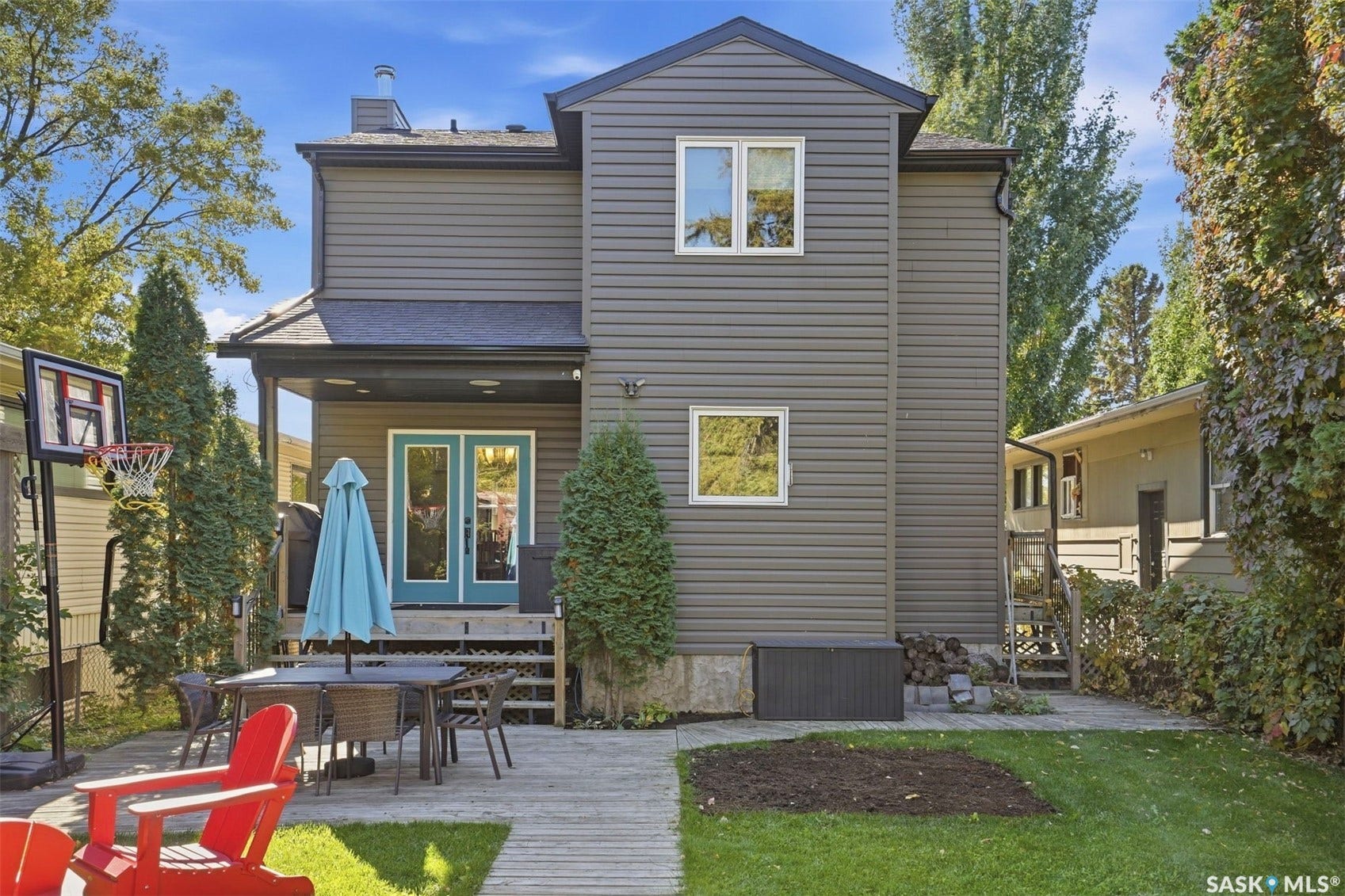 Rear exterior featuring siding, dual pane windows, and a covered patio with French doors