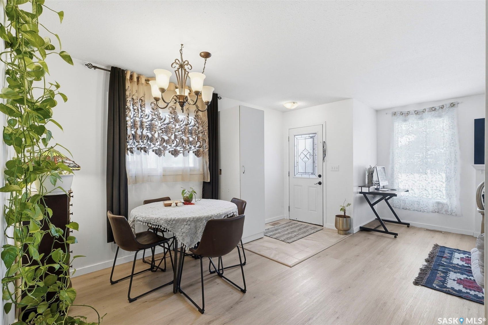 Recessed lighting, wood-finish flooring, and a decorative front entry door with leaded glass panels