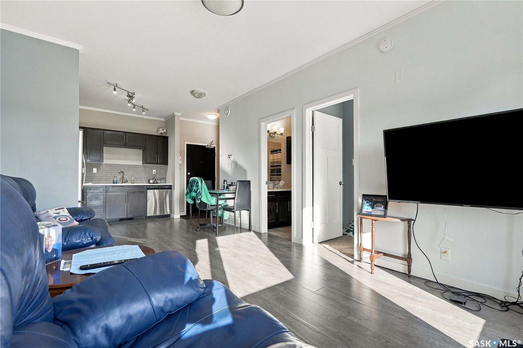 Open concept living area with wood-finish flooring