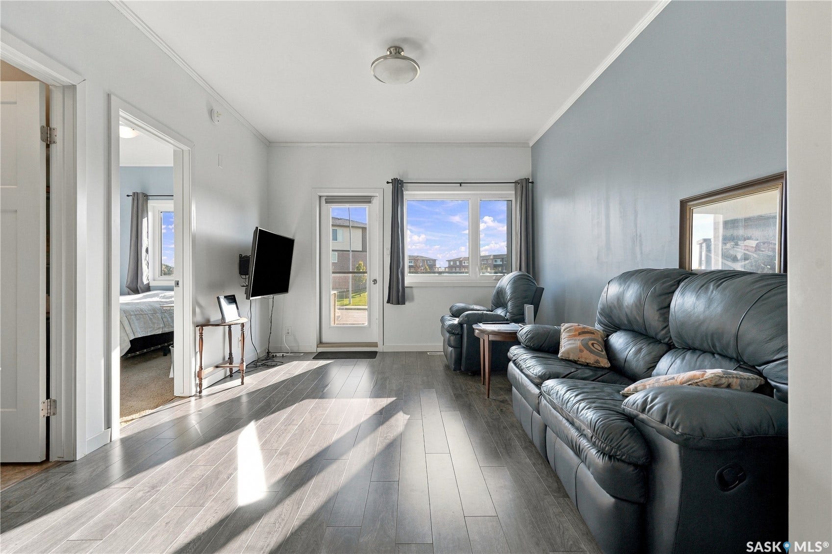 Wood-finish flooring throughout, light-toned wall paint, and a direct access door