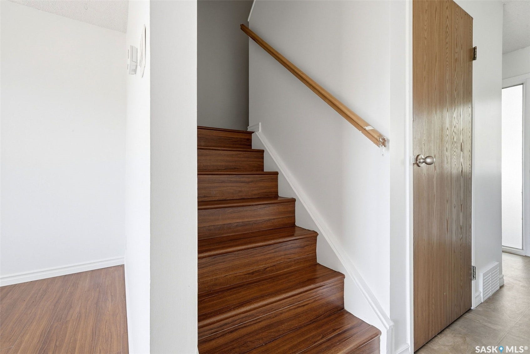 Wood-finish stairs with a natural wood handrail