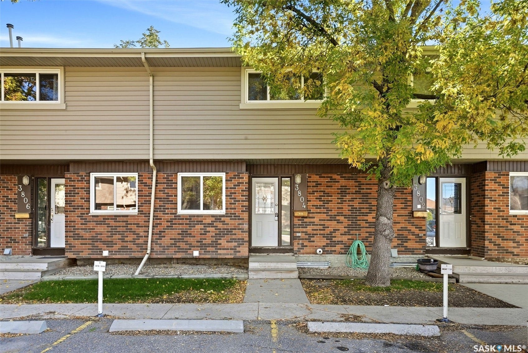 Brick and siding exterior with mature landscaping