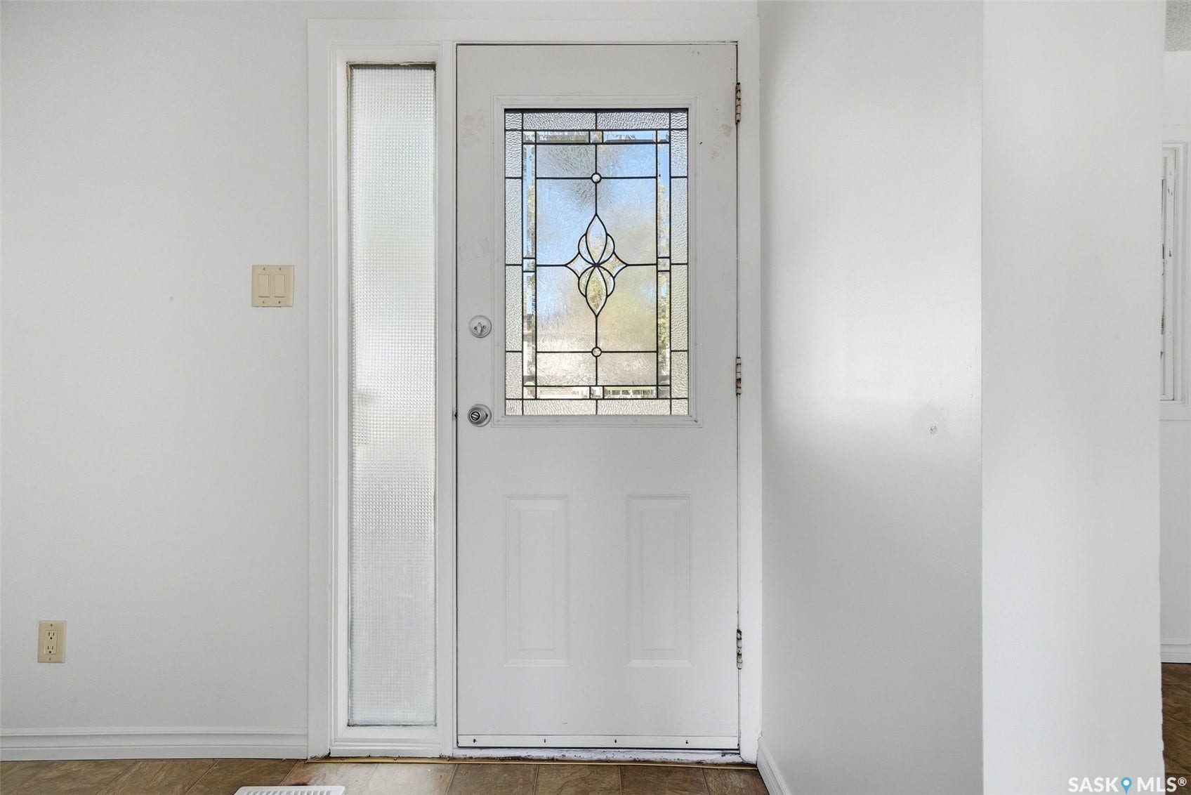 White entry door with decorative leaded glass panel