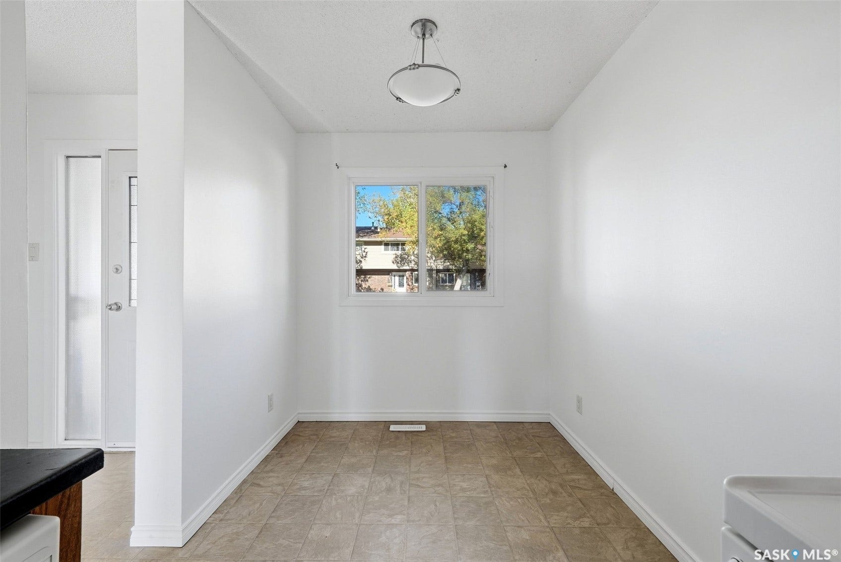 Recessed window with white trim, ceiling-mounted light fixture, and tile-style flooring