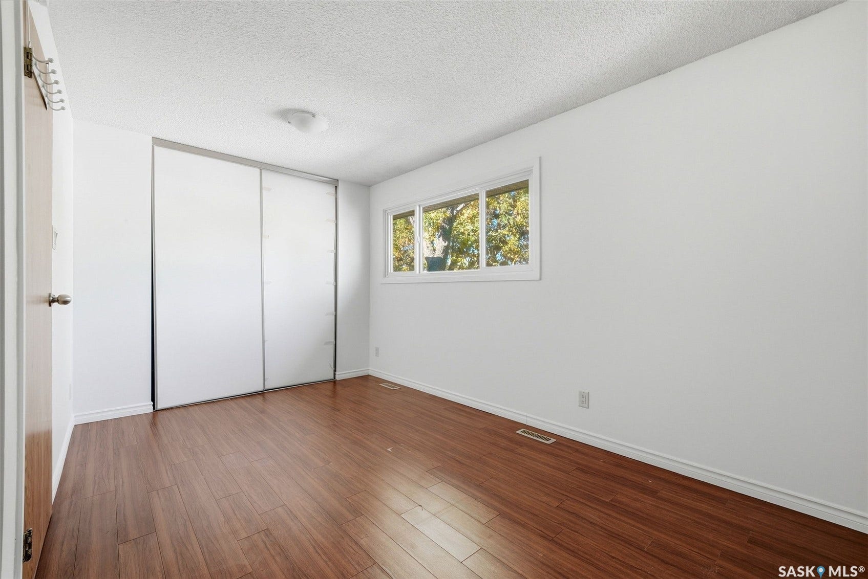 White walls and trim with wood-finish flooring