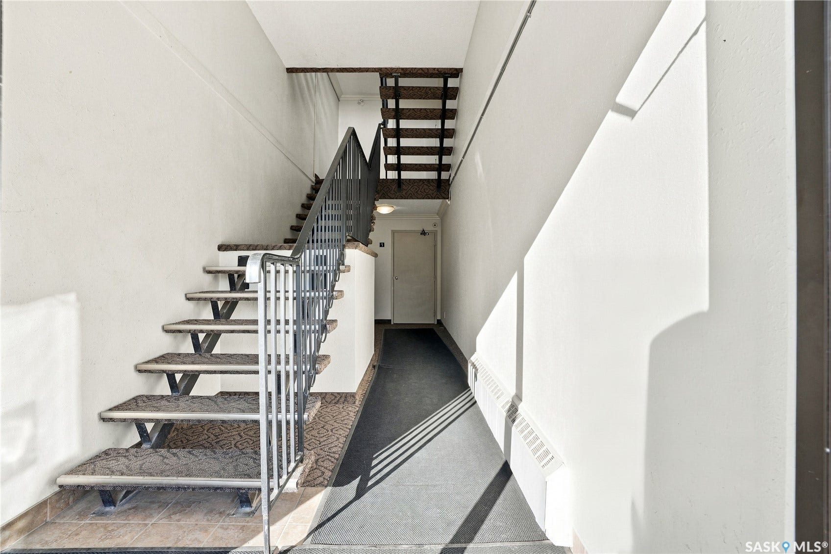 Stairway with patterned treads and metal railing