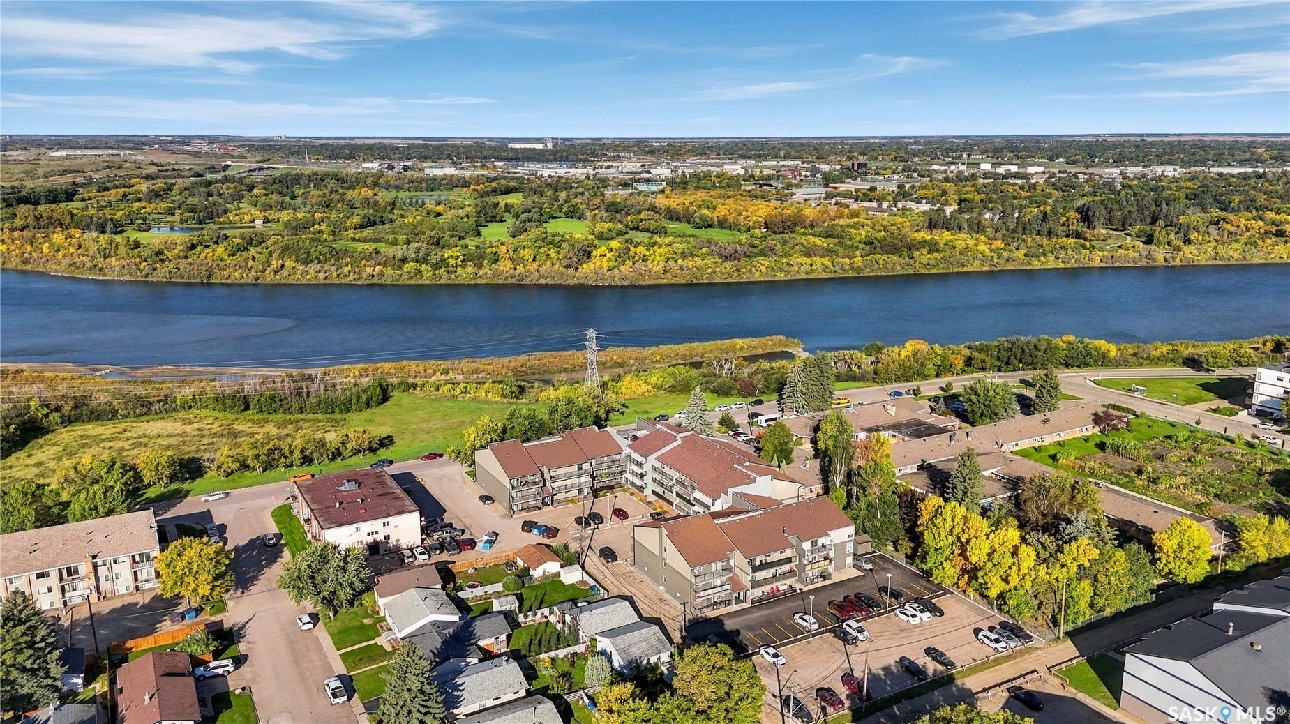 Riverfront properties within a developed urban area, surrounded by mature trees