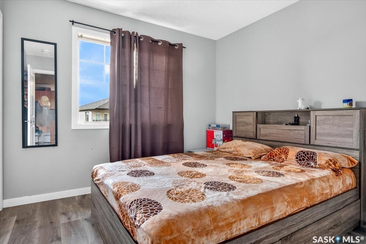 5051 James Hill Road, #107, Regina SK S4W 0B9 Wood-finish flooring, single window, and a built-in headboard with storage