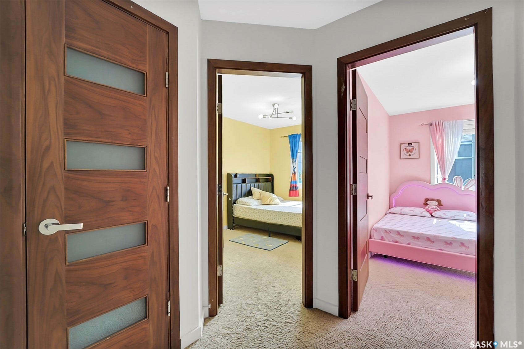 Wood-finish doors with frosted glass panels, bright interior paint, and neutral carpet flooring