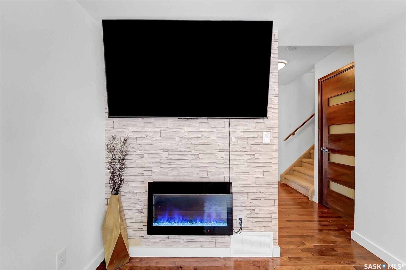 Stacked stone accent wall with an electric fireplace