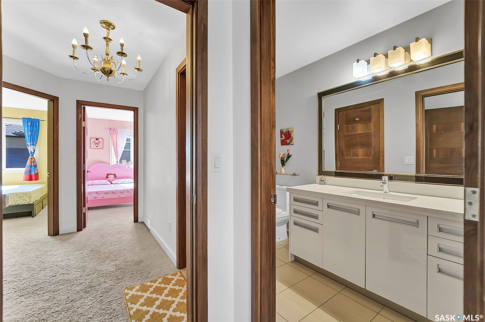 Double vanity with white cabinetry, integrated sinks, and polished chrome fixtures